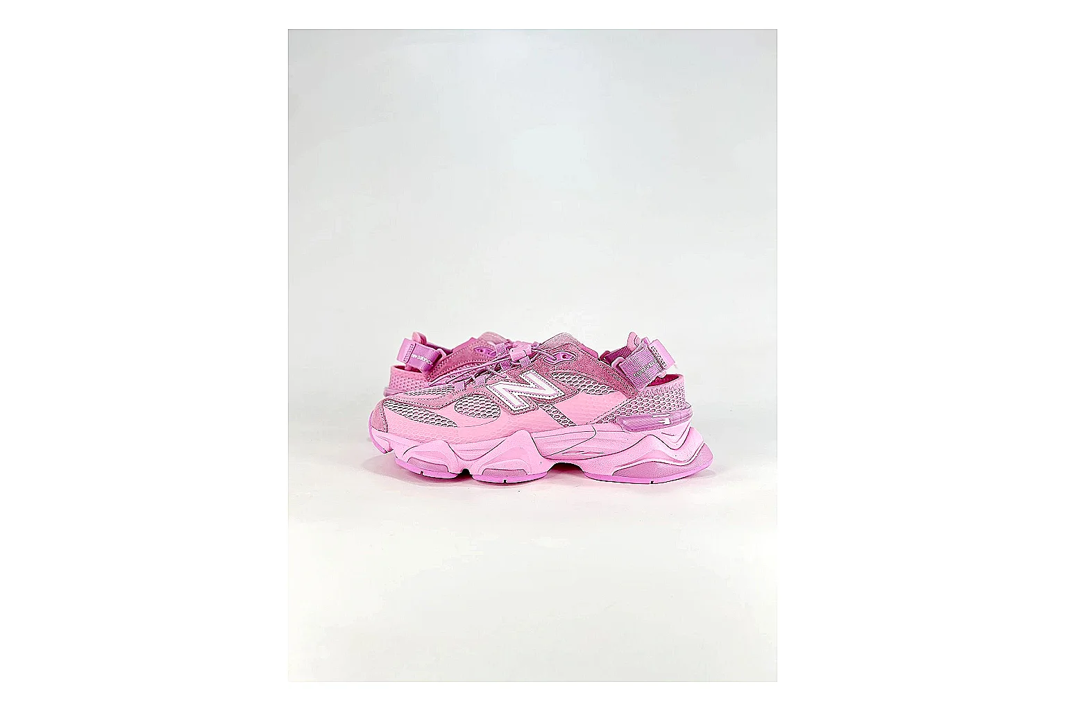 New Balance 9060 Pink Sneakers shopping brief image showing pink chunky runner sneakers with mesh-leather texture, side-profile shape, upper panel lines, and outsole detail
