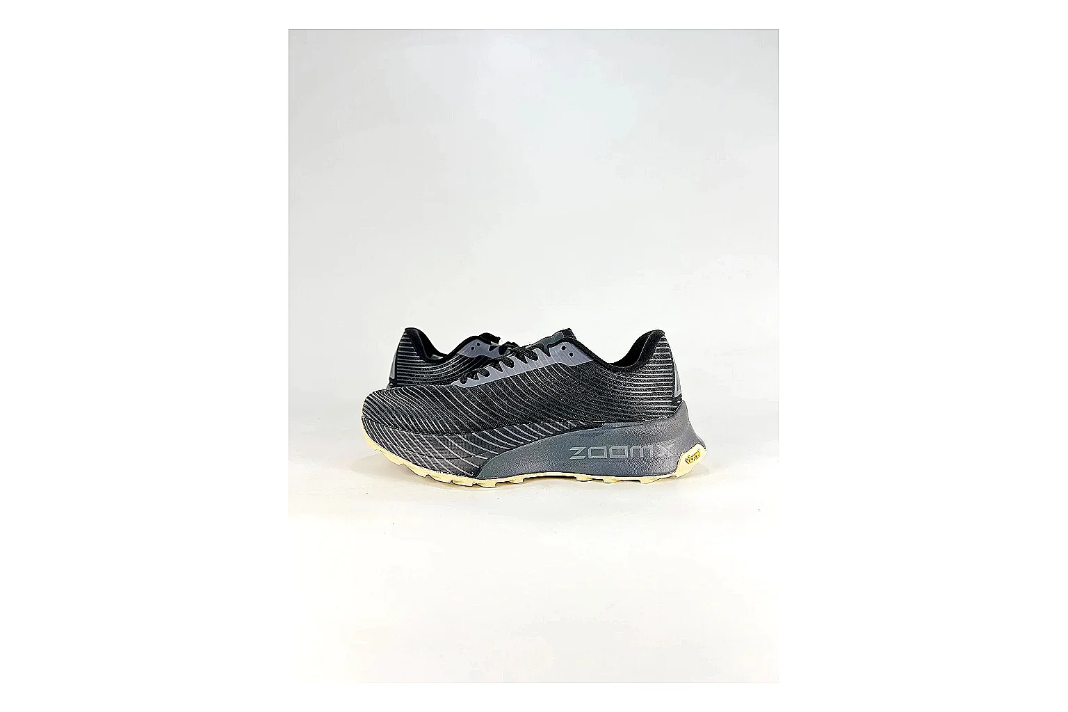 Nike ACG Ultra Black Gum Sneakers shopping brief image showing black gum outdoor sneakers with textile texture, side-profile shape, upper panel lines, and outsole detail