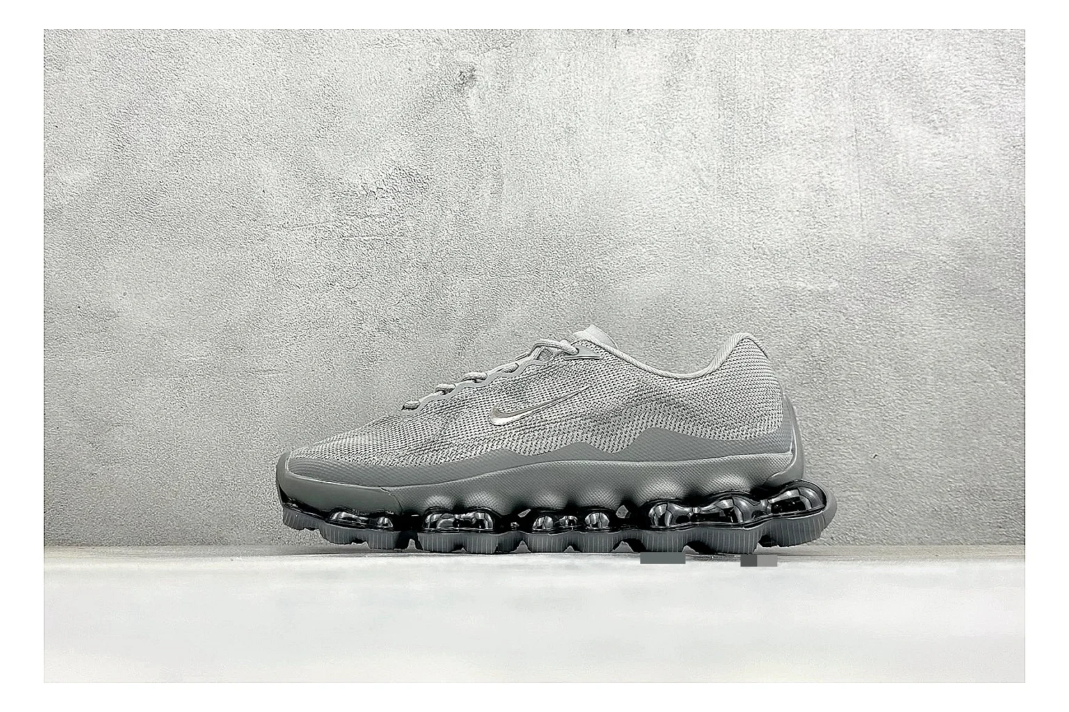 Nike Air Liquid Metal Silver shopping brief image showing reflective silver upper, running-inspired panels, sculpted pod outsole, and glossy tech finish