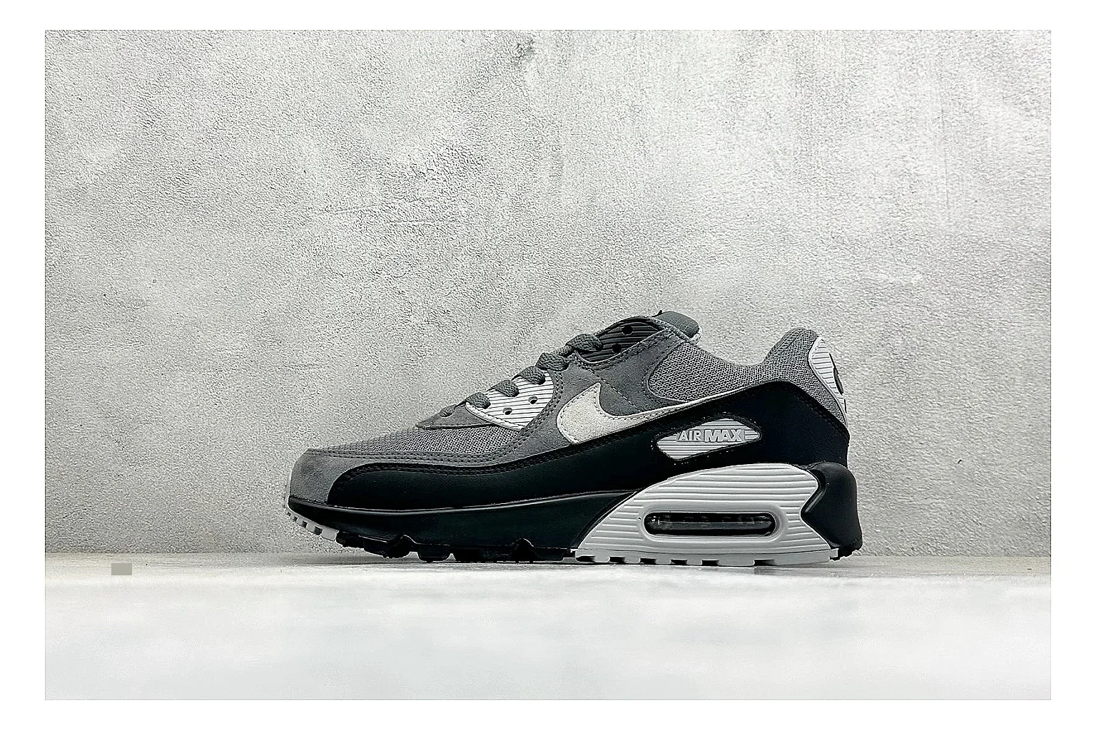 Nike Air Max 90 Grey Black shopping brief photo showing grey and black layered upper, visible Air window, classic Air Max 90 panels, and sturdy retro sole