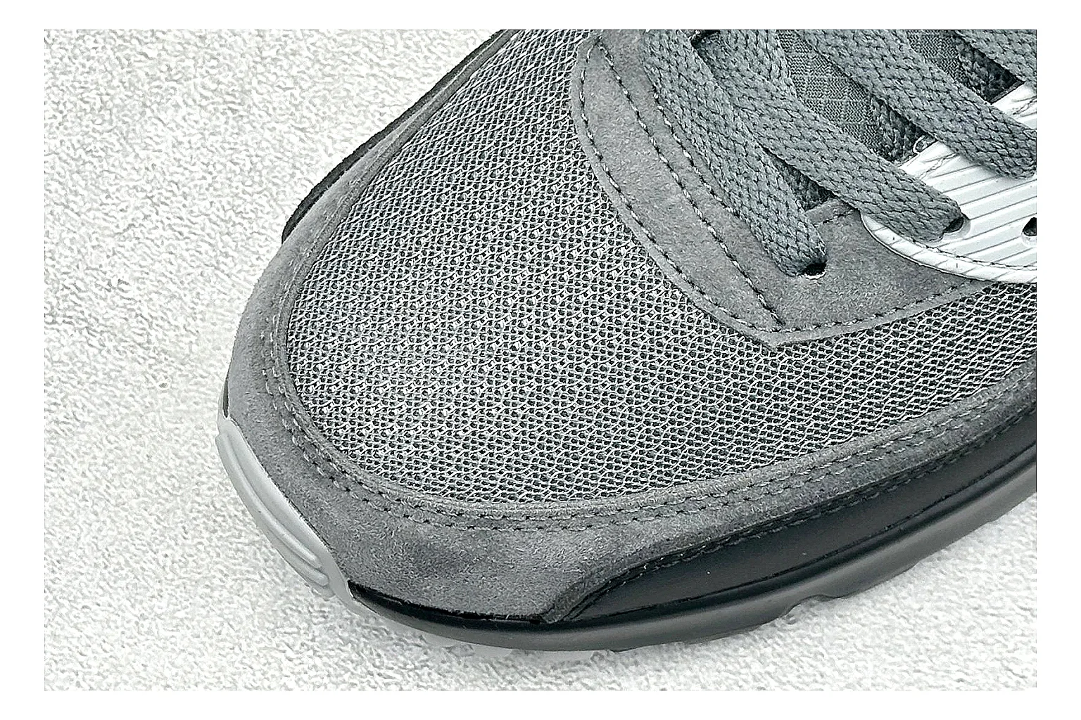 Nike Air Max 90 Grey Black shopping brief photo showing grey and black layered upper, visible Air window, classic Air Max 90 panels, and sturdy retro sole thumbnail 3