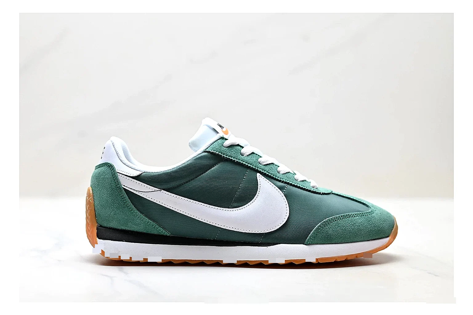 Nike Cortez Green White shopping brief photo showing green white leather low-top upper, slim retro runner profile, Swoosh detail, and classic Cortez sole