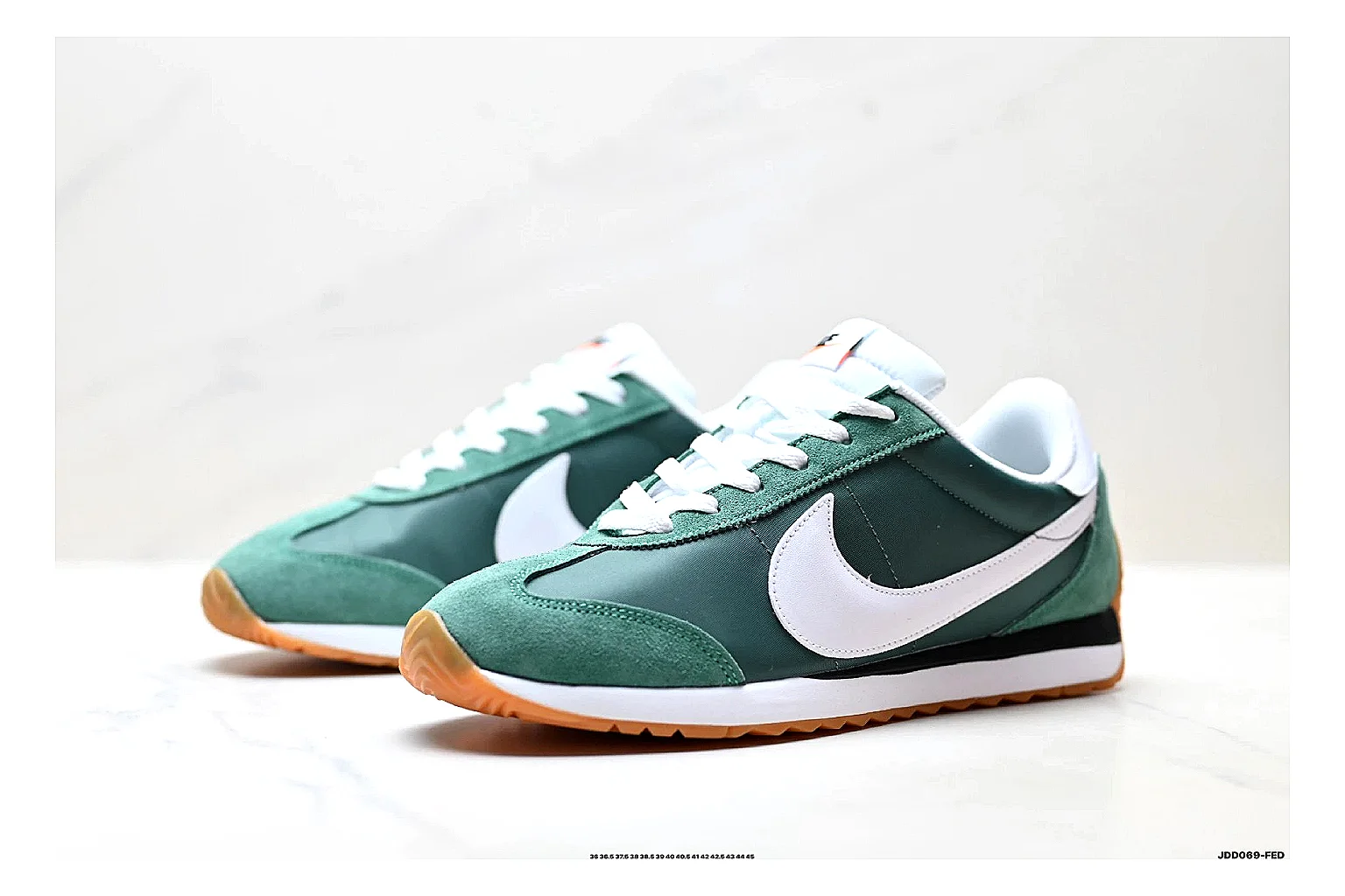 Nike Cortez Green White shopping brief photo showing green white leather low-top upper, slim retro runner profile, Swoosh detail, and classic Cortez sole thumbnail 2