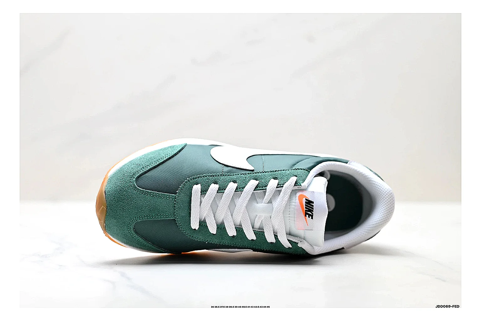 Nike Cortez Green White shopping brief photo showing green white leather low-top upper, slim retro runner profile, Swoosh detail, and classic Cortez sole thumbnail 4