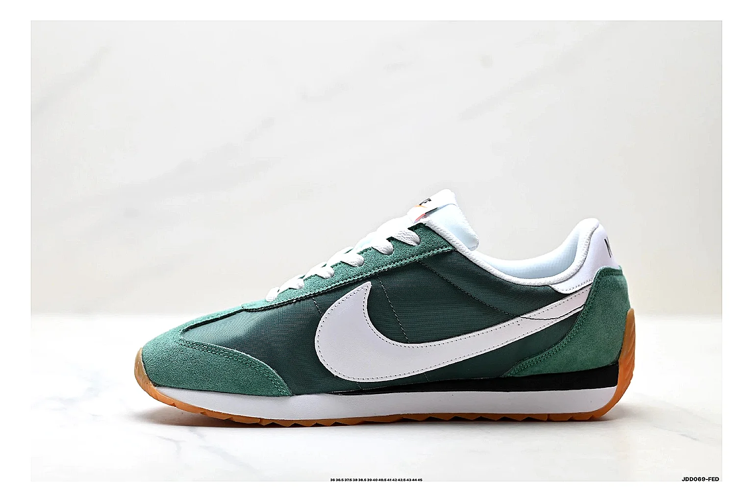 Nike Cortez Green White shopping brief photo showing green white leather low-top upper, slim retro runner profile, Swoosh detail, and classic Cortez sole thumbnail 5