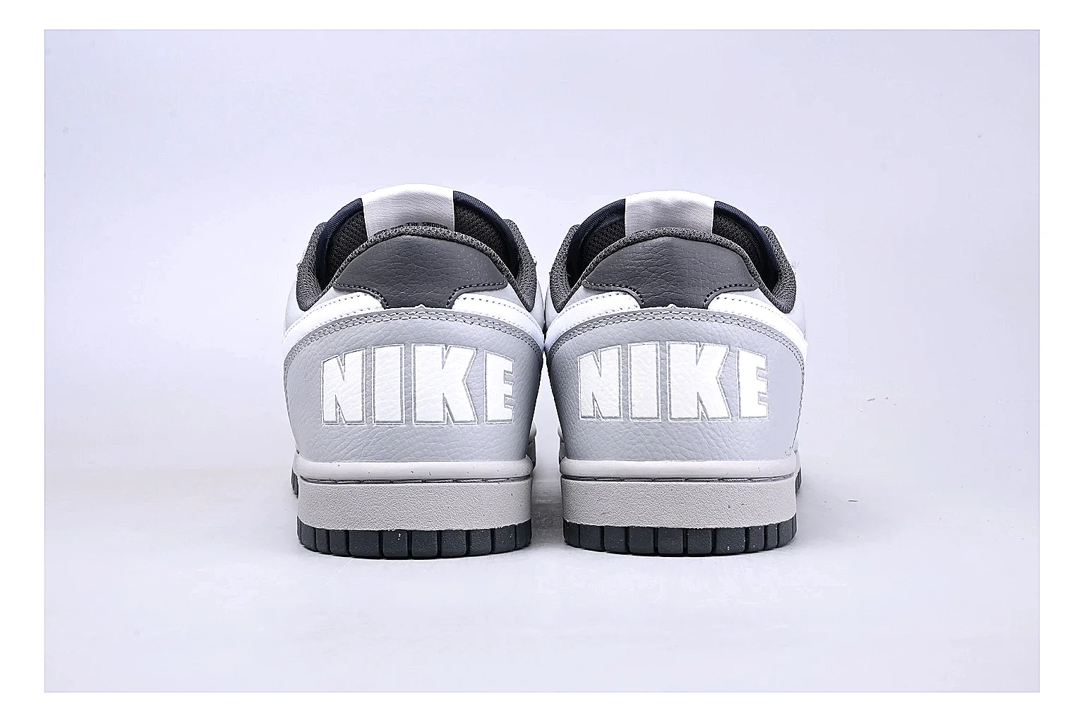 Nike Dunk Low White Gray shopping brief photo showing white and gray leather panels, low Dunk shape, padded collar, and basketball-retro sole thumbnail 2