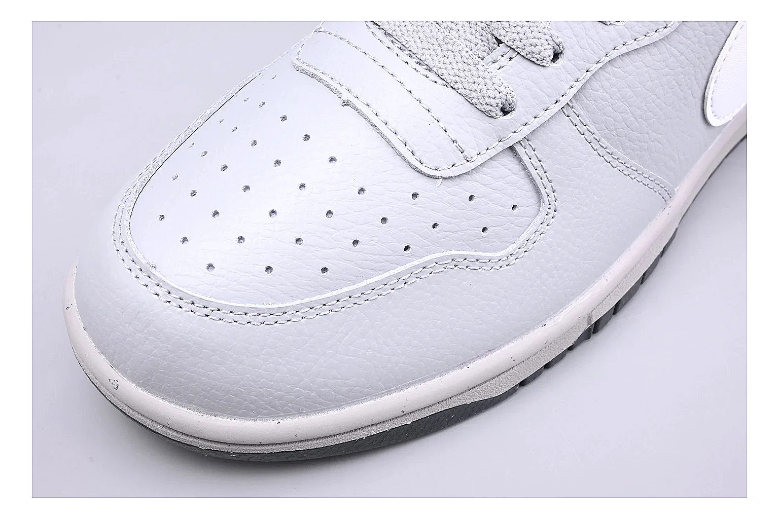 Nike Dunk Low White Gray shopping brief photo showing white and gray leather panels, low Dunk shape, padded collar, and basketball-retro sole thumbnail 3