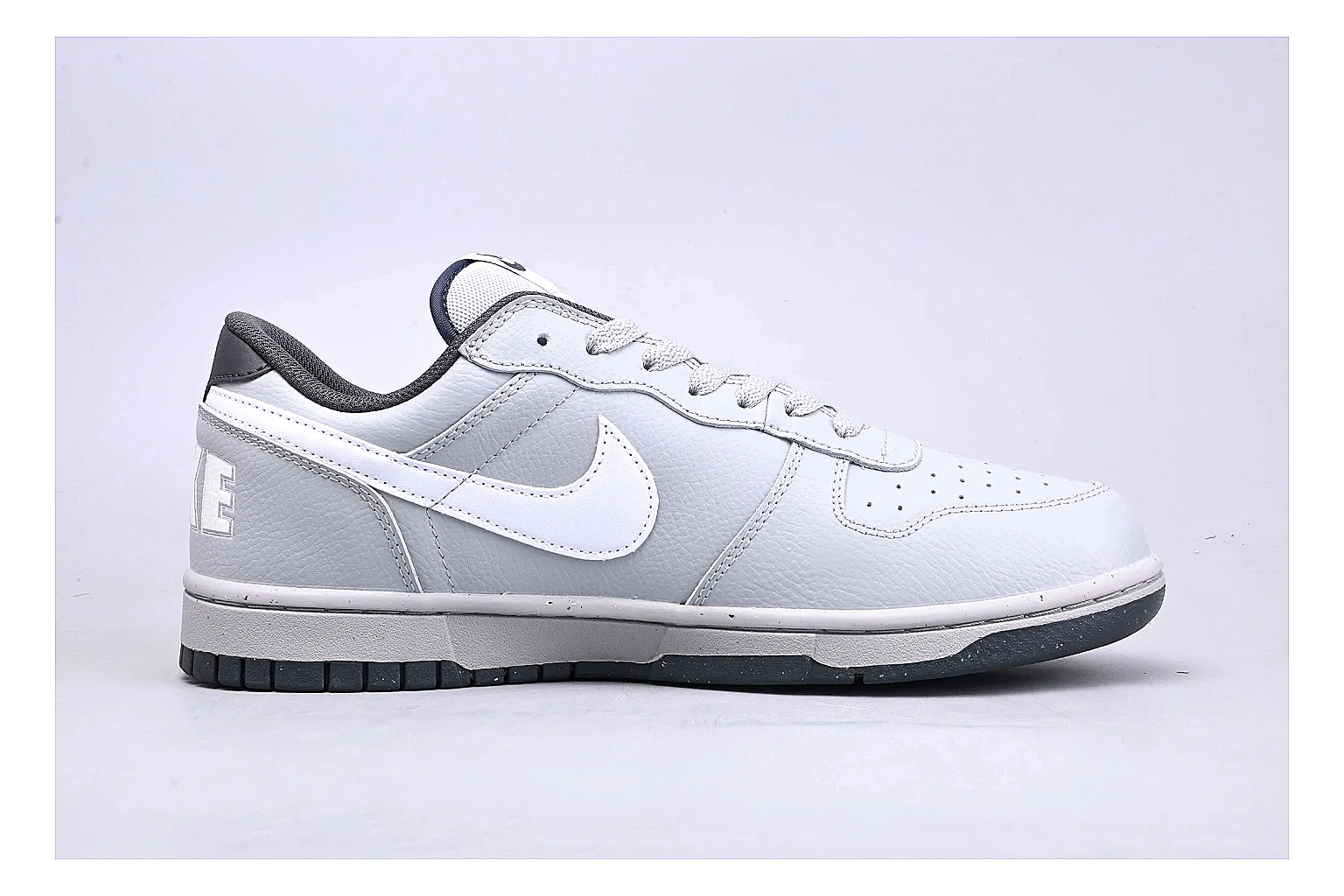 Nike Dunk Low White Gray shopping brief photo showing white and gray leather panels, low Dunk shape, padded collar, and basketball-retro sole thumbnail 4