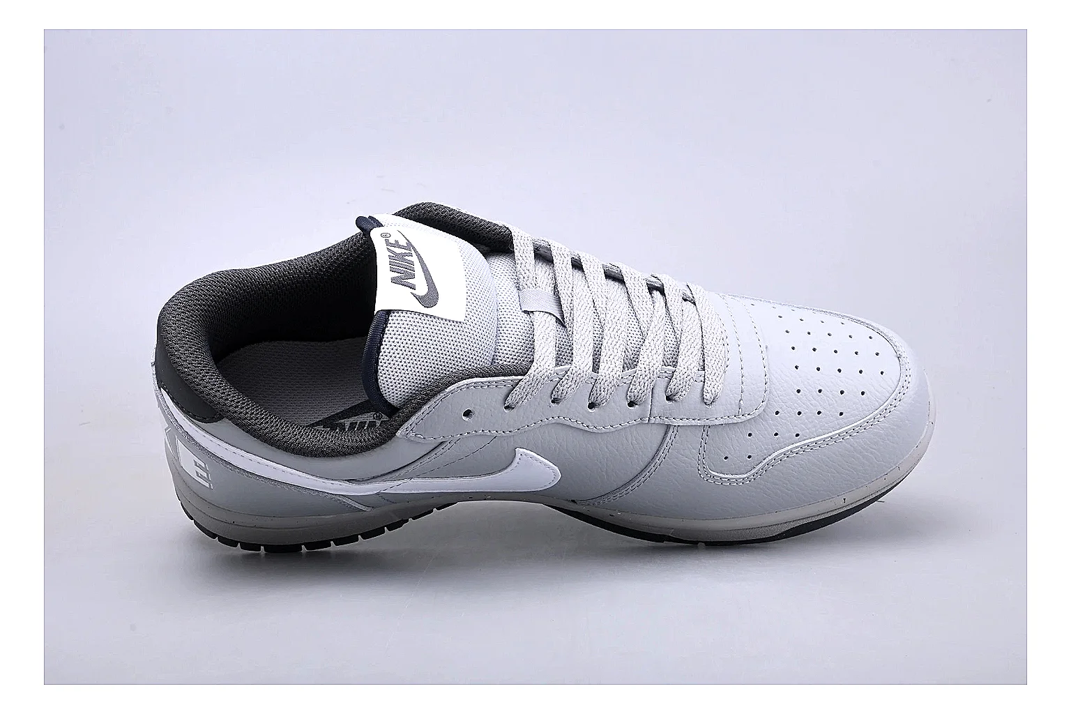Nike Dunk Low White Gray shopping brief photo showing white and gray leather panels, low Dunk shape, padded collar, and basketball-retro sole thumbnail 5