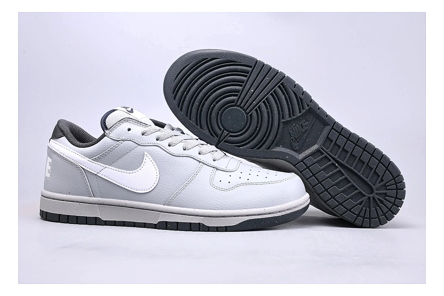 Nike Dunk Low White Gray shopping brief photo showing white and gray leather panels, low Dunk shape, padded collar, and basketball-retro sole thumbnail 6