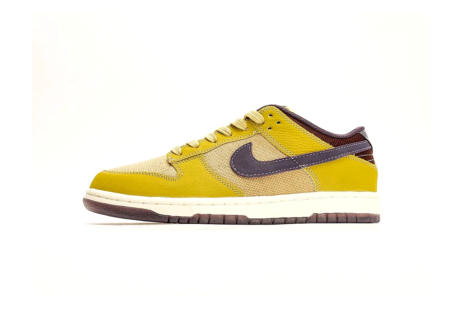 Nike Dunk Low Yellow Purple shopping brief photo showing yellow and purple leather panels, dark Swoosh, heel overlay, cream midsole, and brown outsole