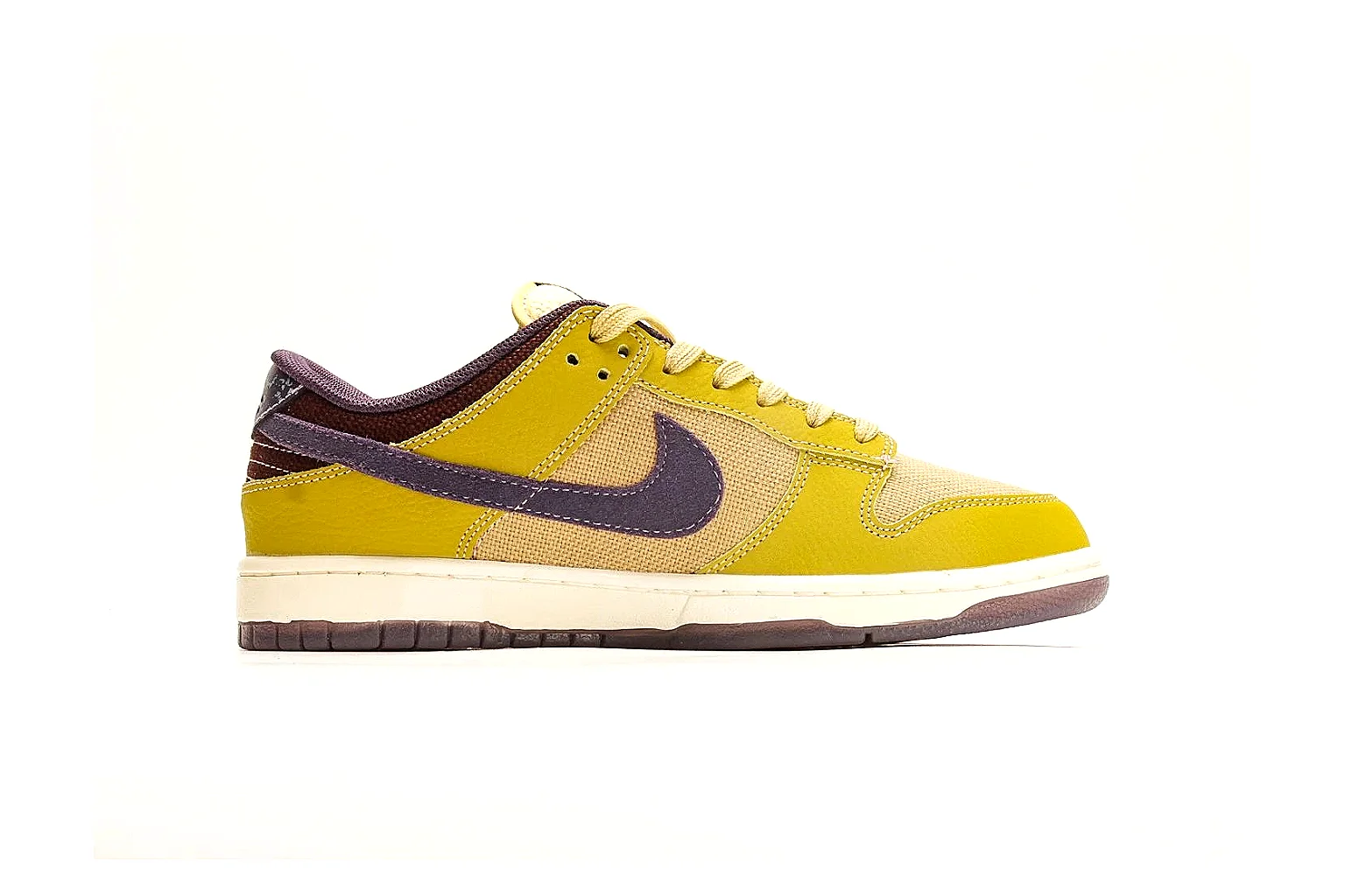 Nike Dunk Low Yellow Purple shopping brief photo showing yellow and purple leather panels, dark Swoosh, heel overlay, cream midsole, and brown outsole thumbnail 4