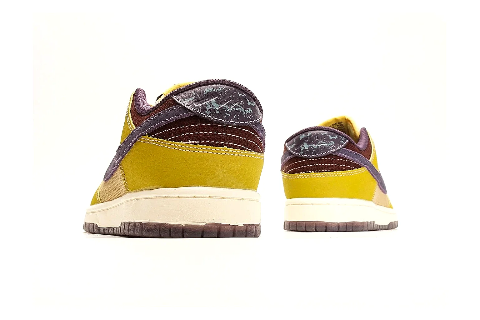 Nike Dunk Low Yellow Purple shopping brief photo showing yellow and purple leather panels, dark Swoosh, heel overlay, cream midsole, and brown outsole thumbnail 6