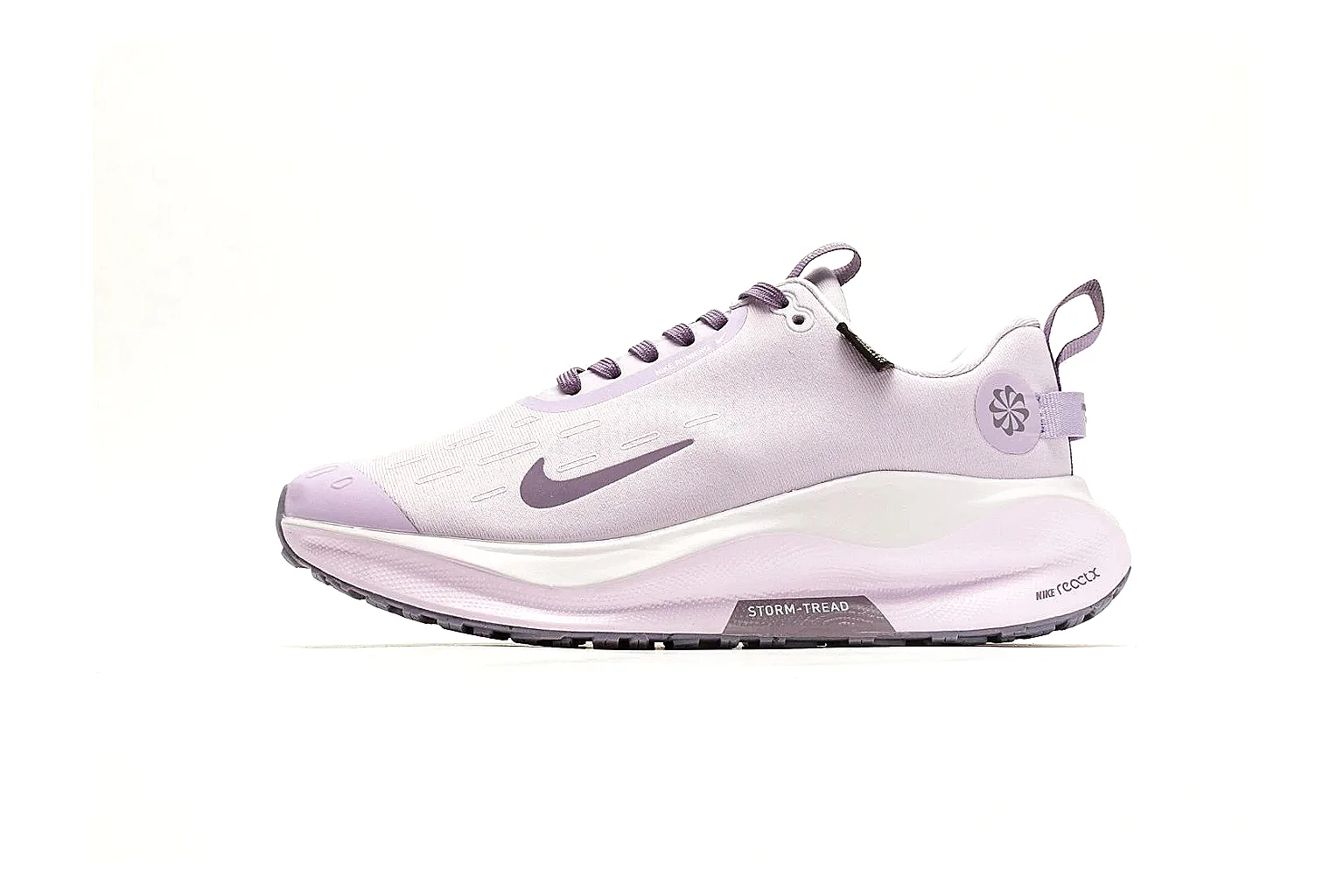 Nike ReactX GORE-TEX Lilac Sneakers shopping brief photo showing lilac textile upper, small Swoosh, heel pull tabs, cushioned ReactX-style sole, and weather-ready low profile