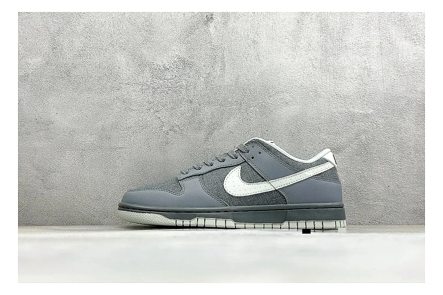 Nike SB Dunk Low Grey shopping brief photo showing grey low-top skate upper, white Swoosh, padded collar, and classic Dunk sole