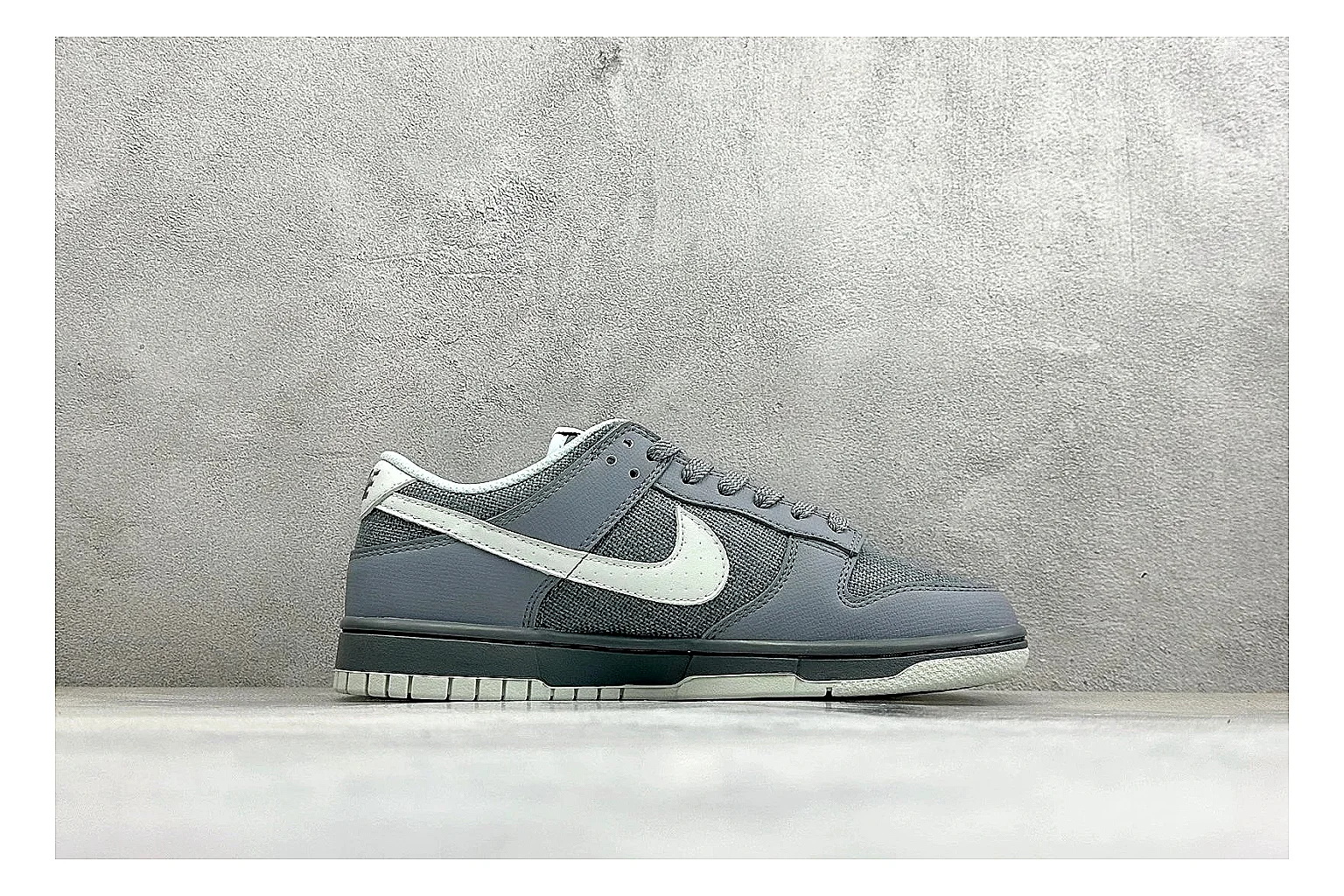 Nike SB Dunk Low Grey shopping brief photo showing grey low-top skate upper, white Swoosh, padded collar, and classic Dunk sole thumbnail 4