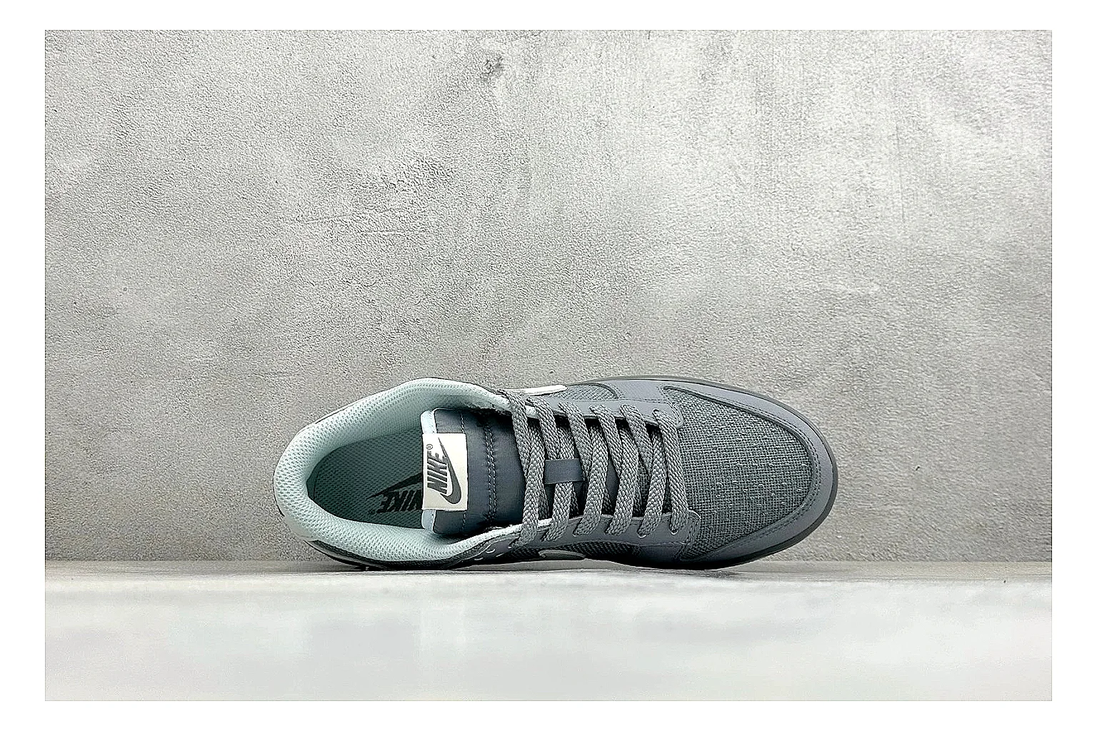 Nike SB Dunk Low Grey shopping brief photo showing grey low-top skate upper, white Swoosh, padded collar, and classic Dunk sole thumbnail 5