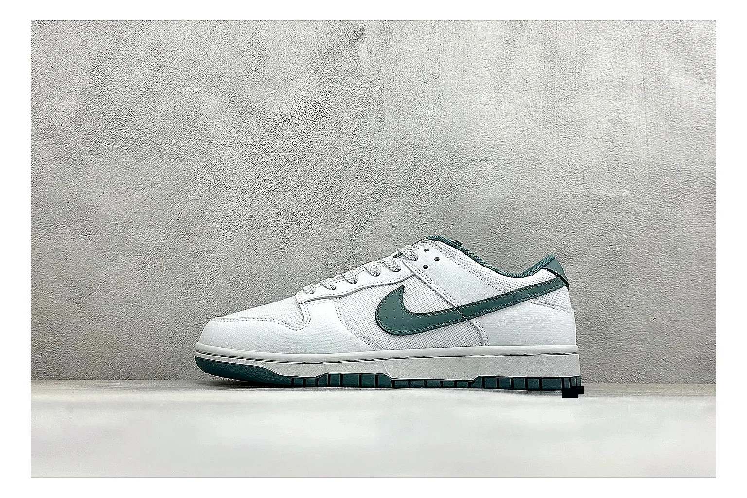 Nike SB Dunk Low White Green shopping brief photo showing white low-top skate upper, green Swoosh, padded collar, and classic Dunk sole shape