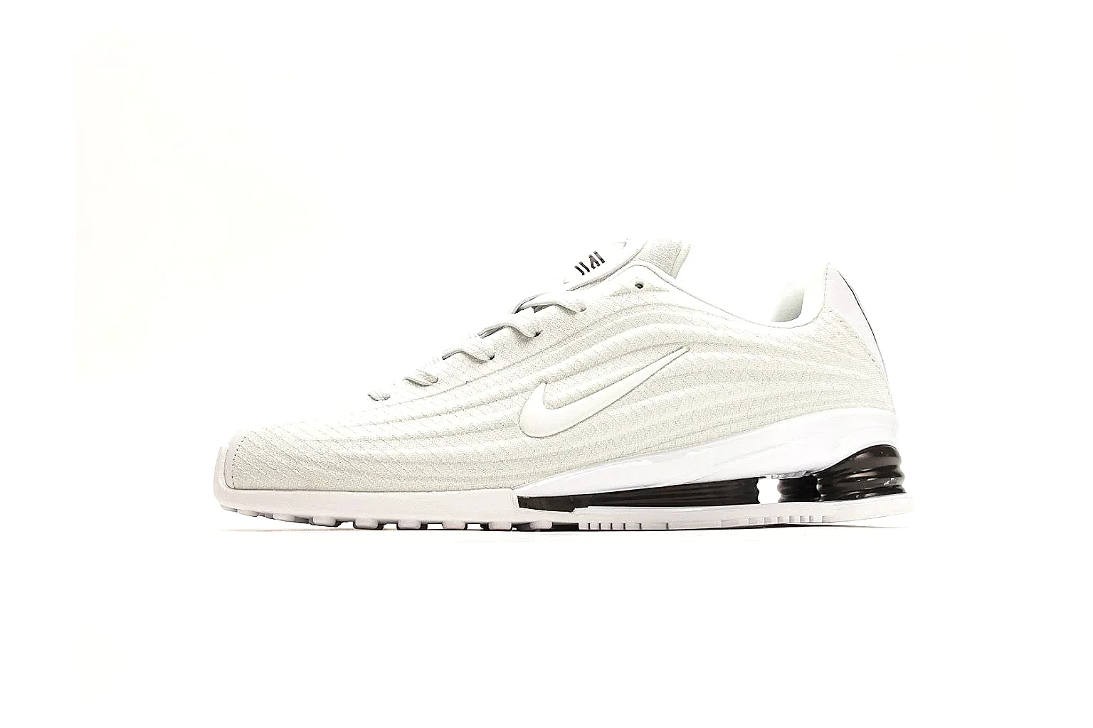 Nike Shox Z White Sneakers shopping brief photo showing white streamlined layered upper, small Swoosh, black heel cushioning columns, and modern low runner shape