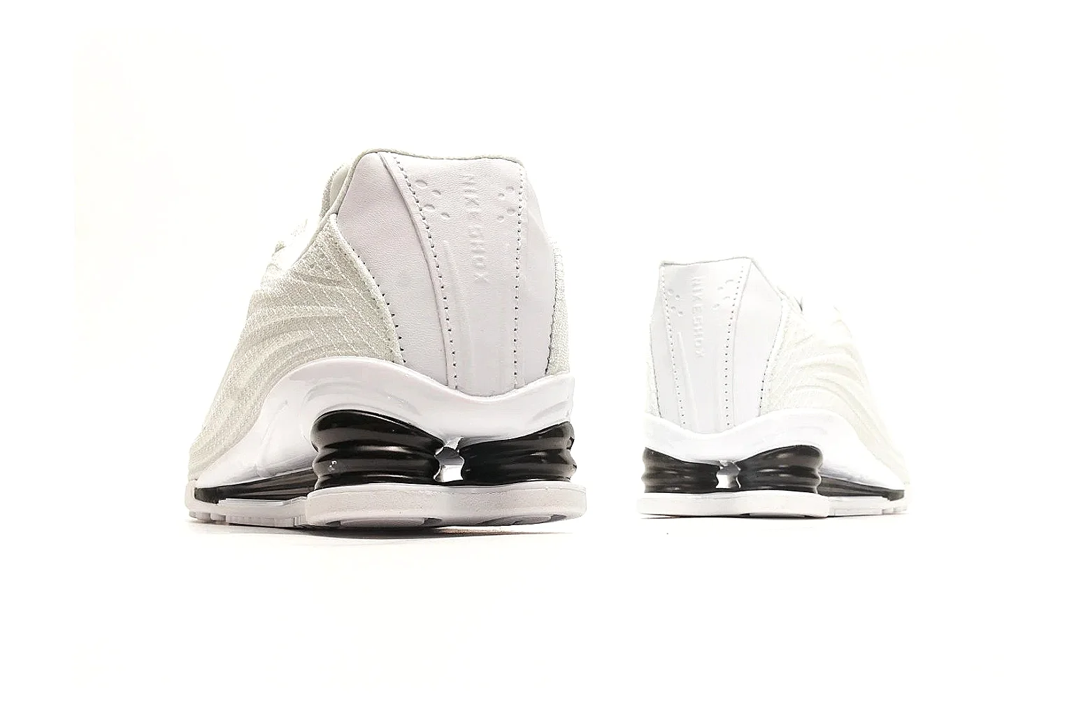 Nike Shox Z White Sneakers shopping brief photo showing white streamlined layered upper, small Swoosh, black heel cushioning columns, and modern low runner shape thumbnail 6