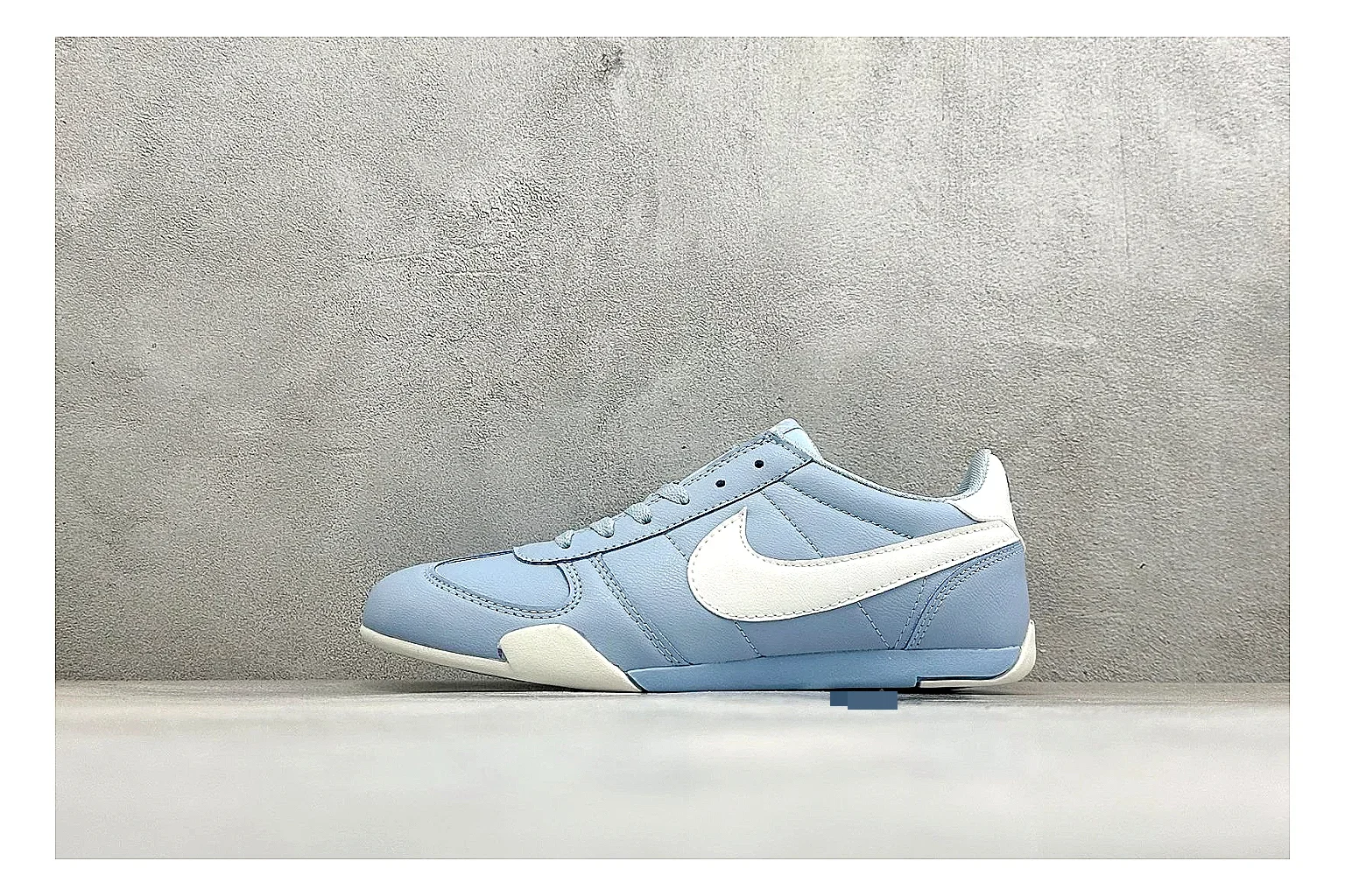 Nike Sprint Sister Light Blue shopping brief photo showing light blue retro-runner upper, slim side profile, tonal panels, and low everyday sole