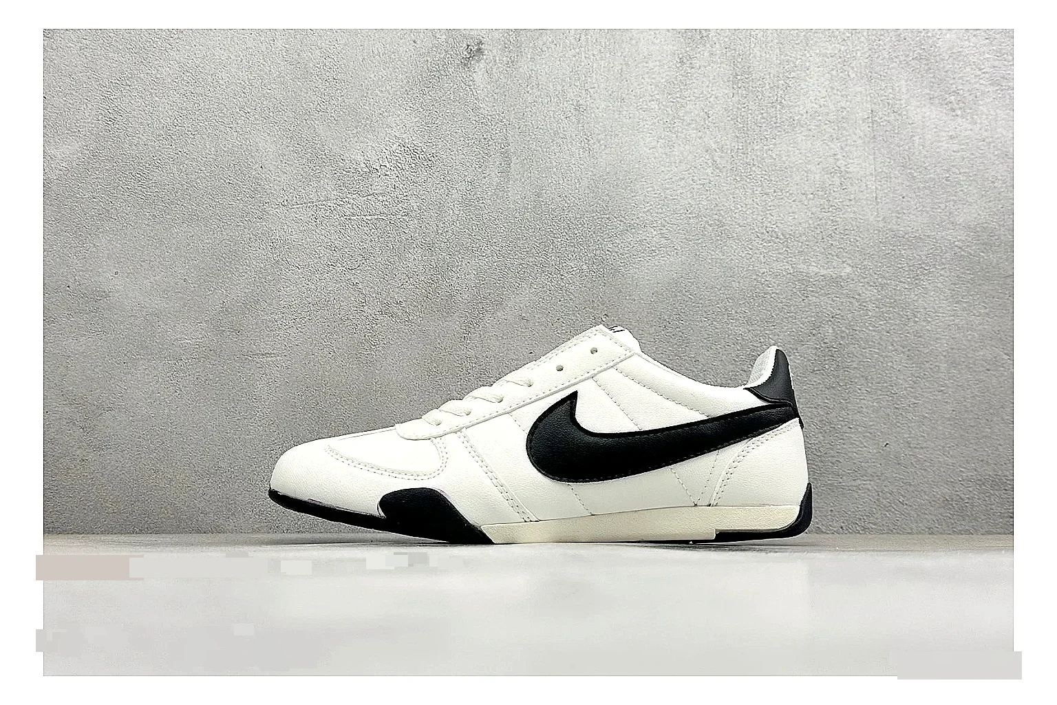 Nike Sprint Sister White Black shopping brief photo showing white retro-runner upper, black Swoosh contrast, slim low-top profile, and light casual sole