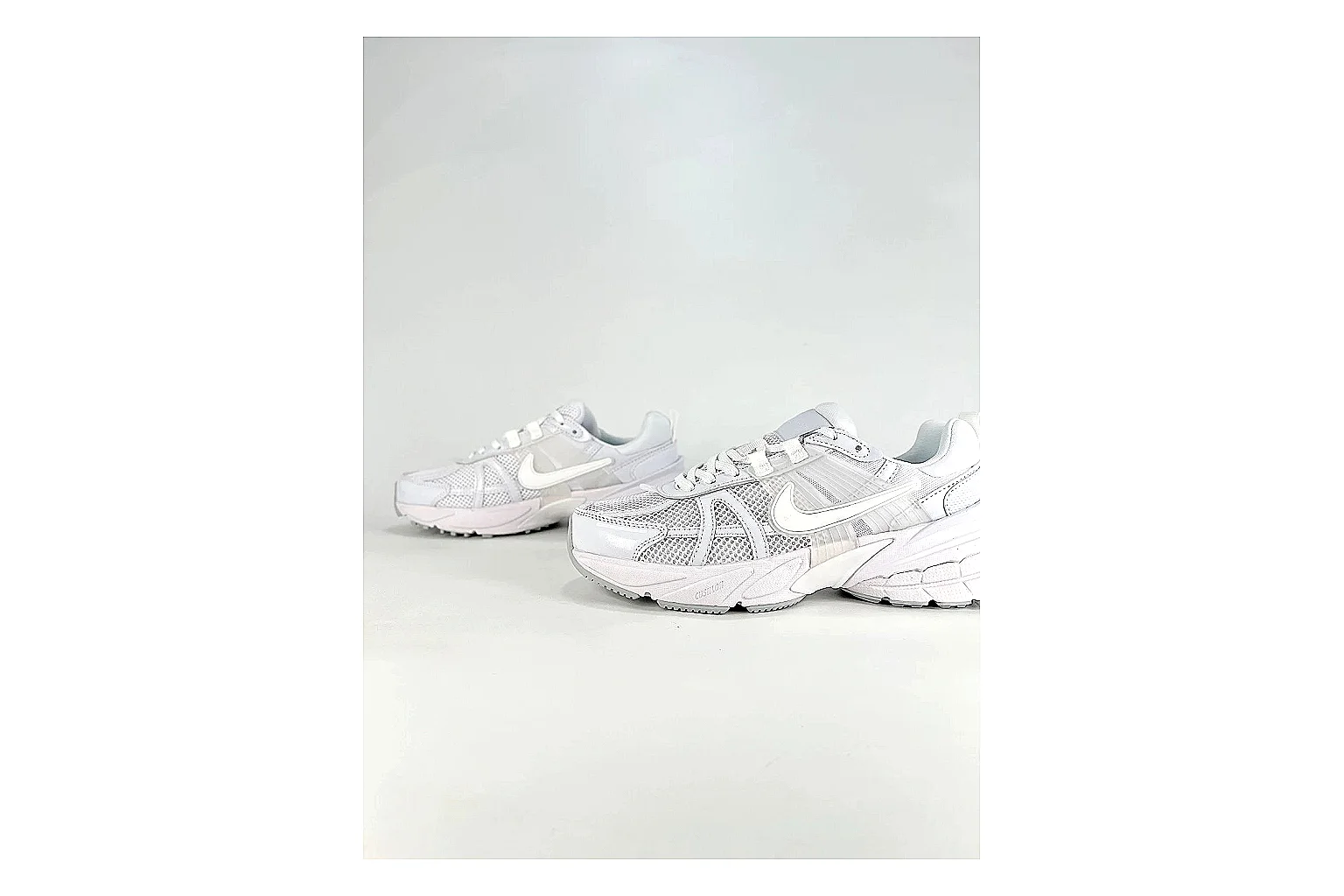 Nike V2K Run White Sneakers shopping brief image showing white retro runner sneakers with mesh-leather texture, side-profile shape, upper panel lines, and outsole detail thumbnail 3