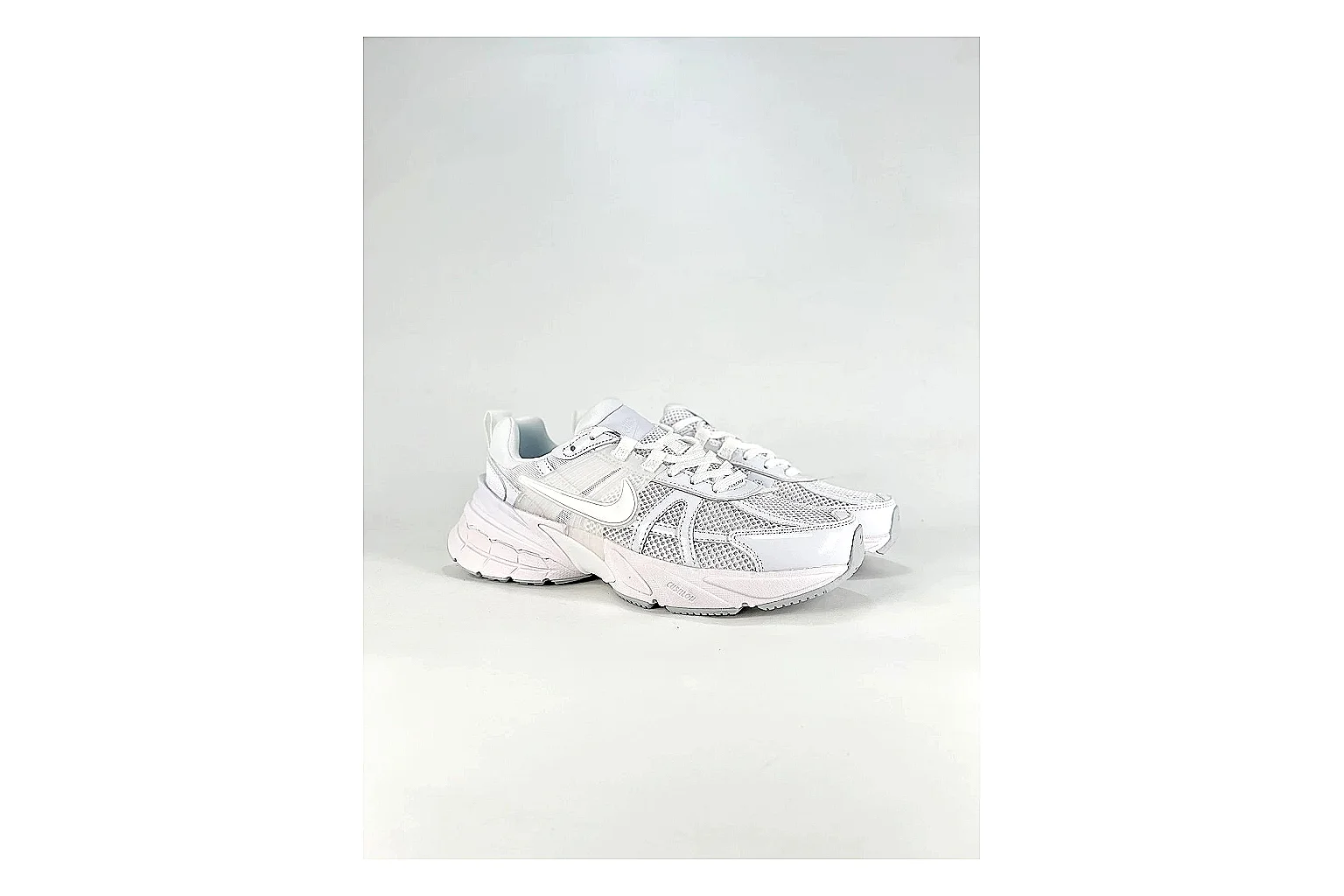 Nike V2K Run White Sneakers shopping brief image showing white retro runner sneakers with mesh-leather texture, side-profile shape, upper panel lines, and outsole detail thumbnail 4