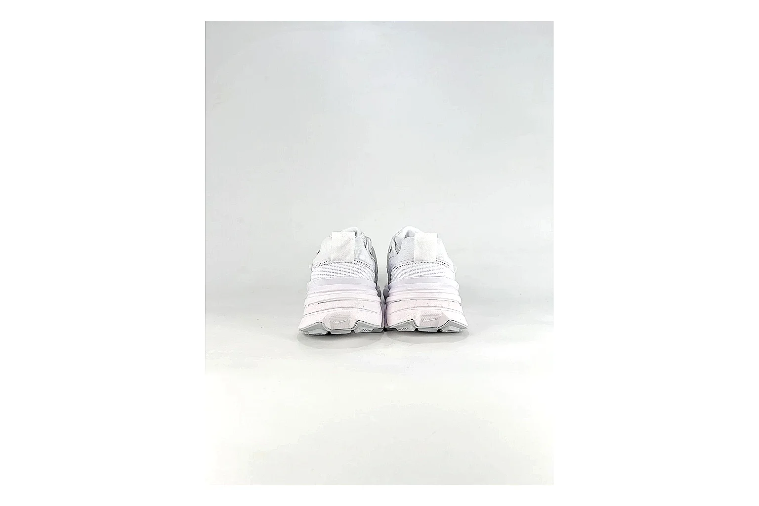 Nike V2K Run White Sneakers shopping brief image showing white retro runner sneakers with mesh-leather texture, side-profile shape, upper panel lines, and outsole detail thumbnail 6