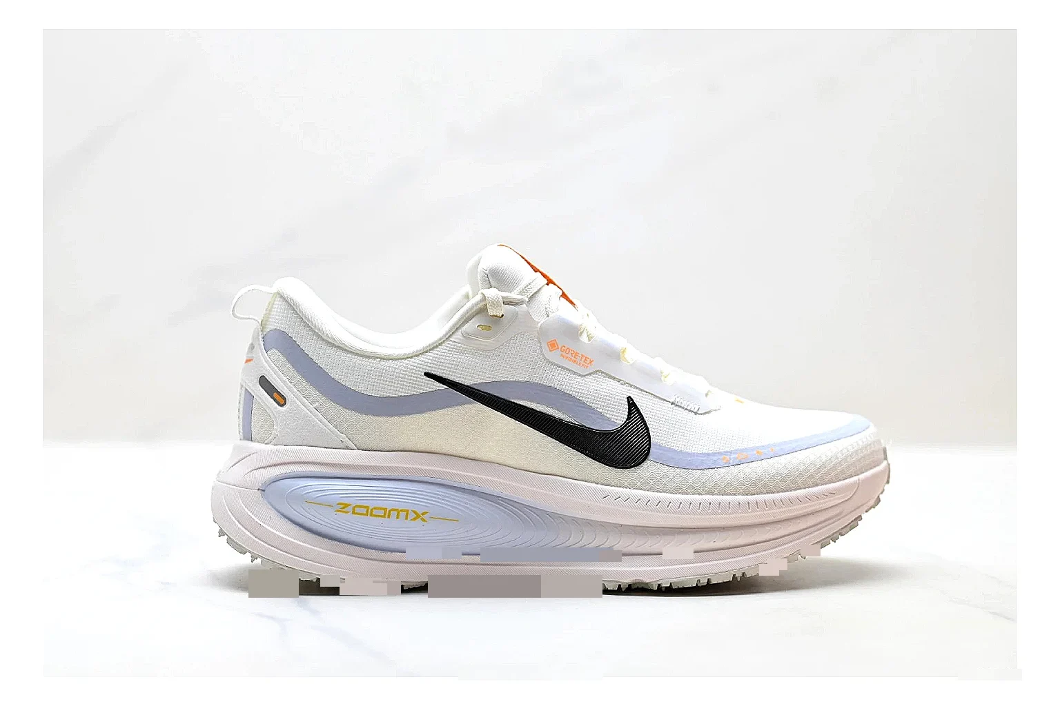 Nike Vomero White Orange shopping brief photo showing white mesh runner upper, orange accents, layered Vomero-style panels, and cushioned modern sole