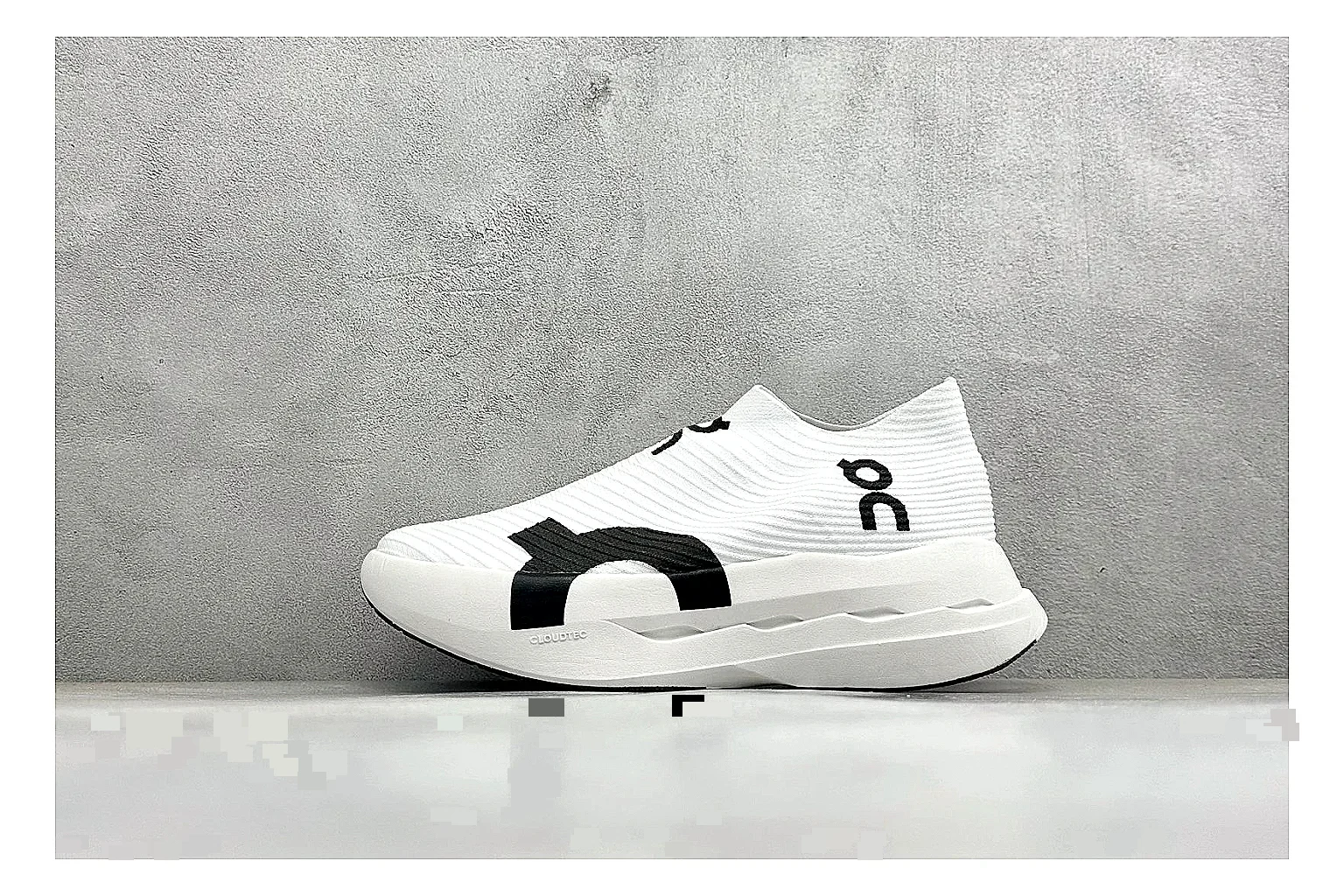 On Cloudboom White Black shopping brief photo showing white performance mesh, black contrast details, slim racing profile, and segmented CloudTec sole