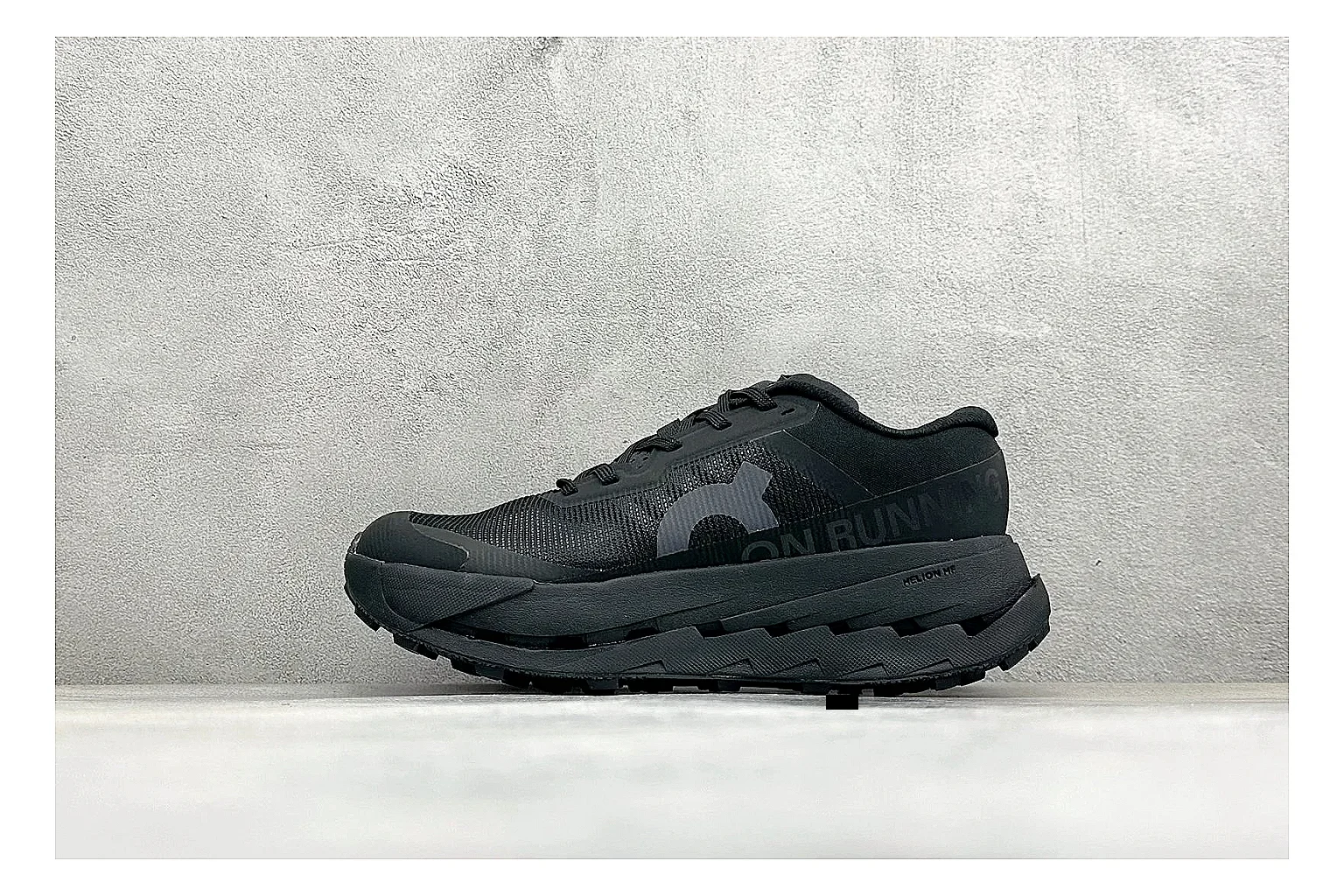 On Cloudmonster Triple Black shopping brief photo showing triple black running upper, oversized CloudTec pod sole, tonal laces, and rounded performance shape