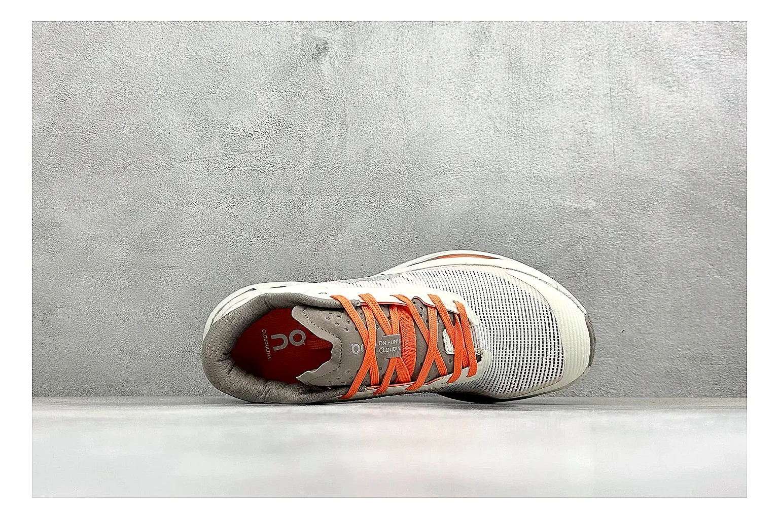 On Cloudmonster White Orange shopping brief photo showing white running mesh, orange accent hits, oversized CloudTec sole pods, and a rounded runner silhouette thumbnail 5