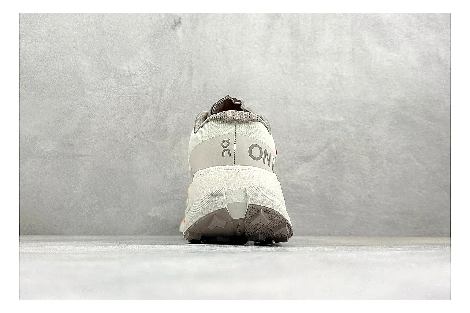 On Cloudmonster White Orange shopping brief photo showing white running mesh, orange accent hits, oversized CloudTec sole pods, and a rounded runner silhouette thumbnail 6