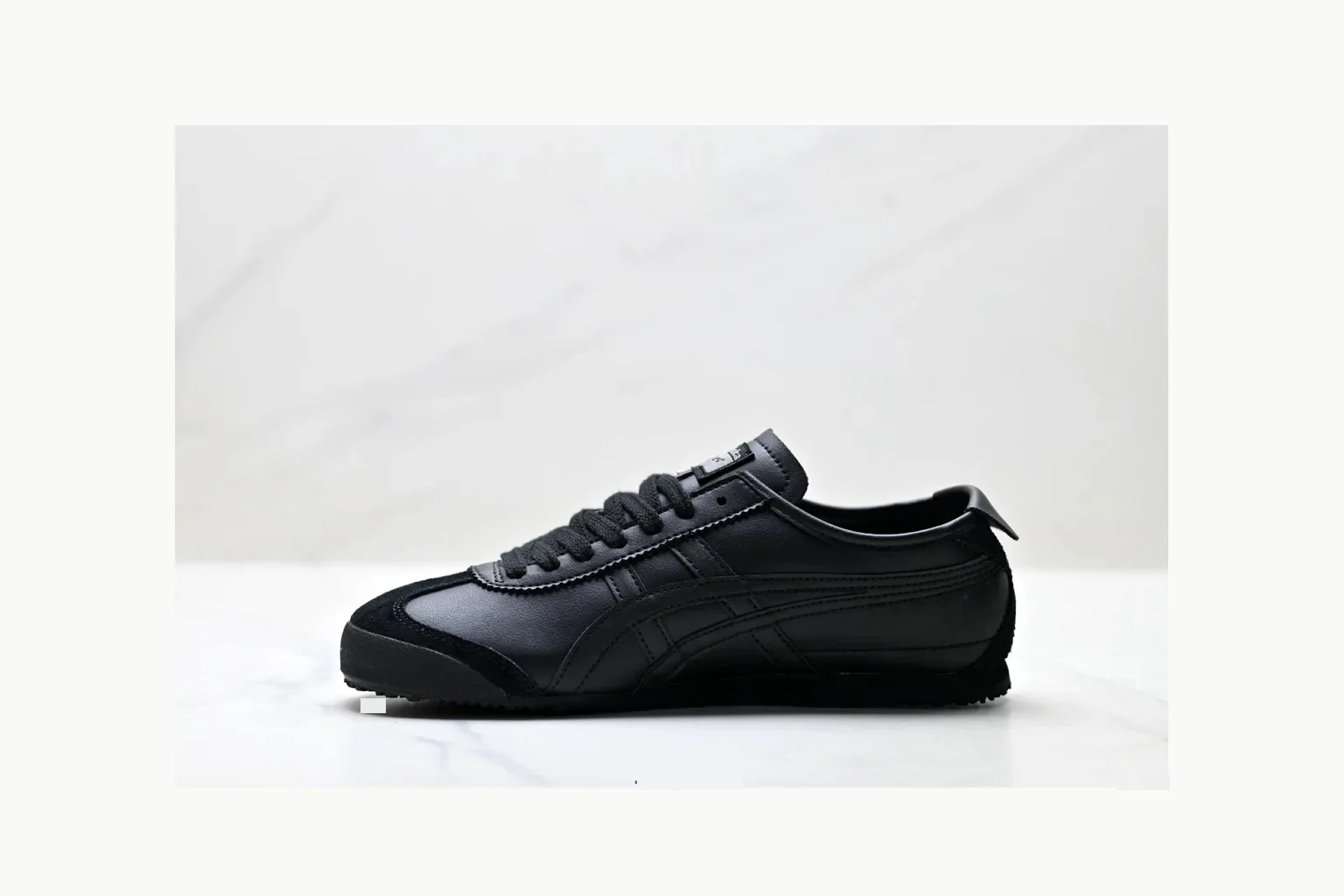 Onitsuka Tiger Black Leather Sneaker shopping brief image showing black black leather retro low-top with leather upper and low top shape