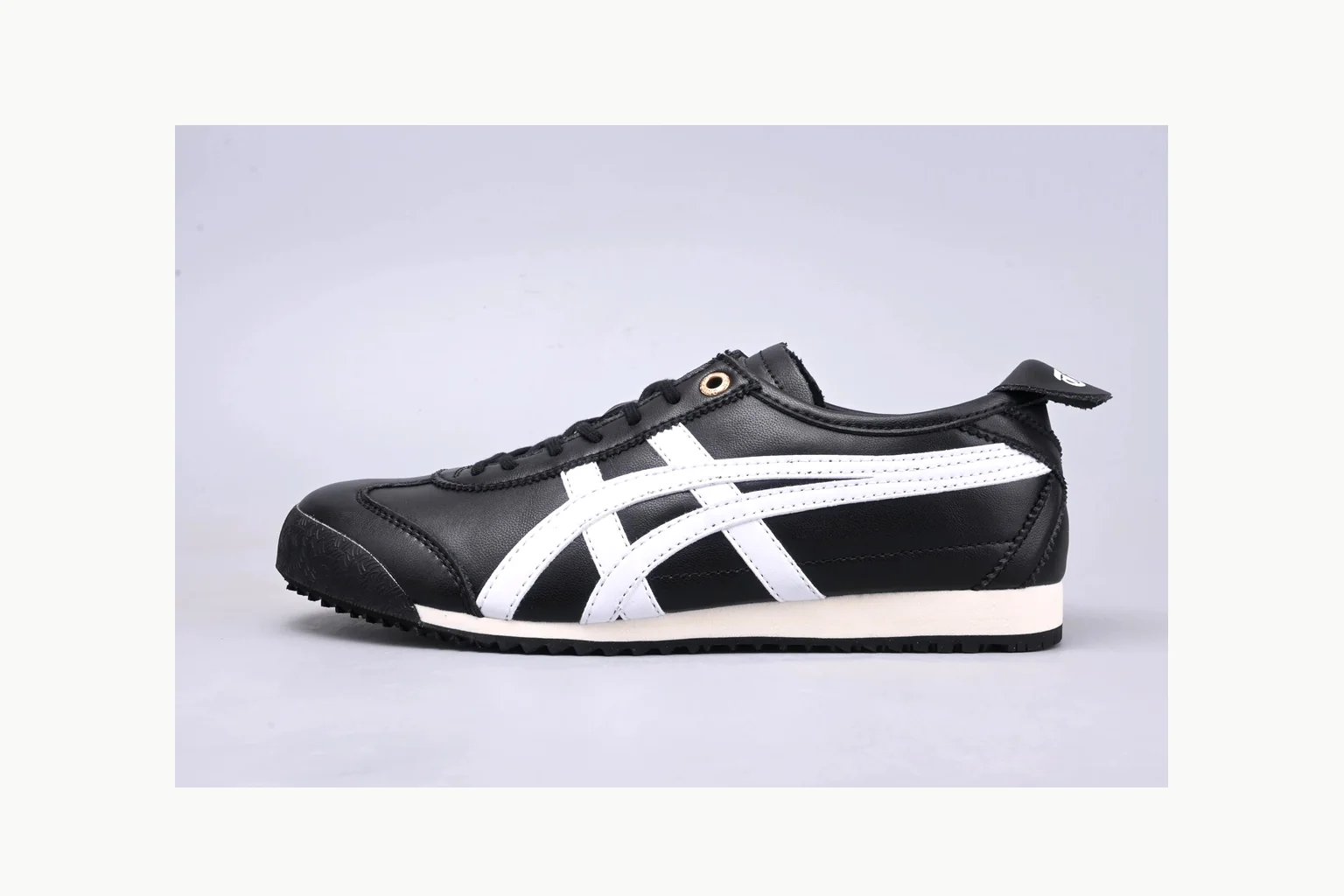 Onitsuka Tiger Black White Sneaker shopping brief image showing white black onitsuka tiger with mixed upper and low top shape