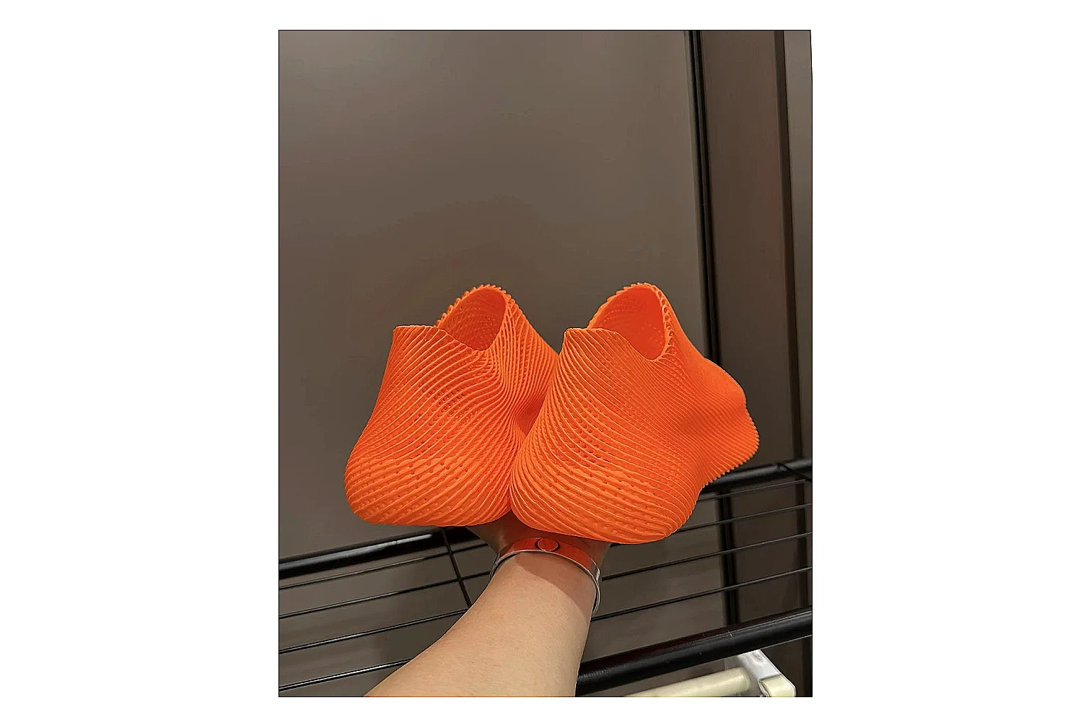 Other 4D Printed Orange Slip-On Sneakers shopping brief photo showing orange open-grid upper, seamless slip-on shape, sculpted sole, and futuristic lightweight profile thumbnail 2