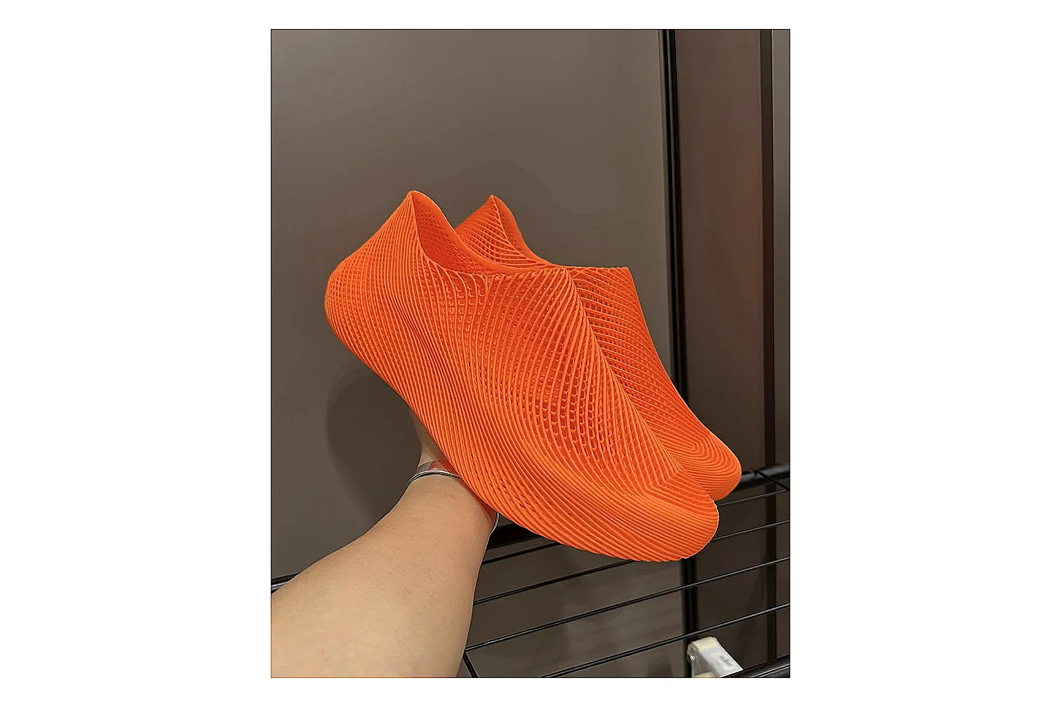 Other 4D Printed Orange Slip-On Sneakers shopping brief photo showing orange open-grid upper, seamless slip-on shape, sculpted sole, and futuristic lightweight profile thumbnail 5
