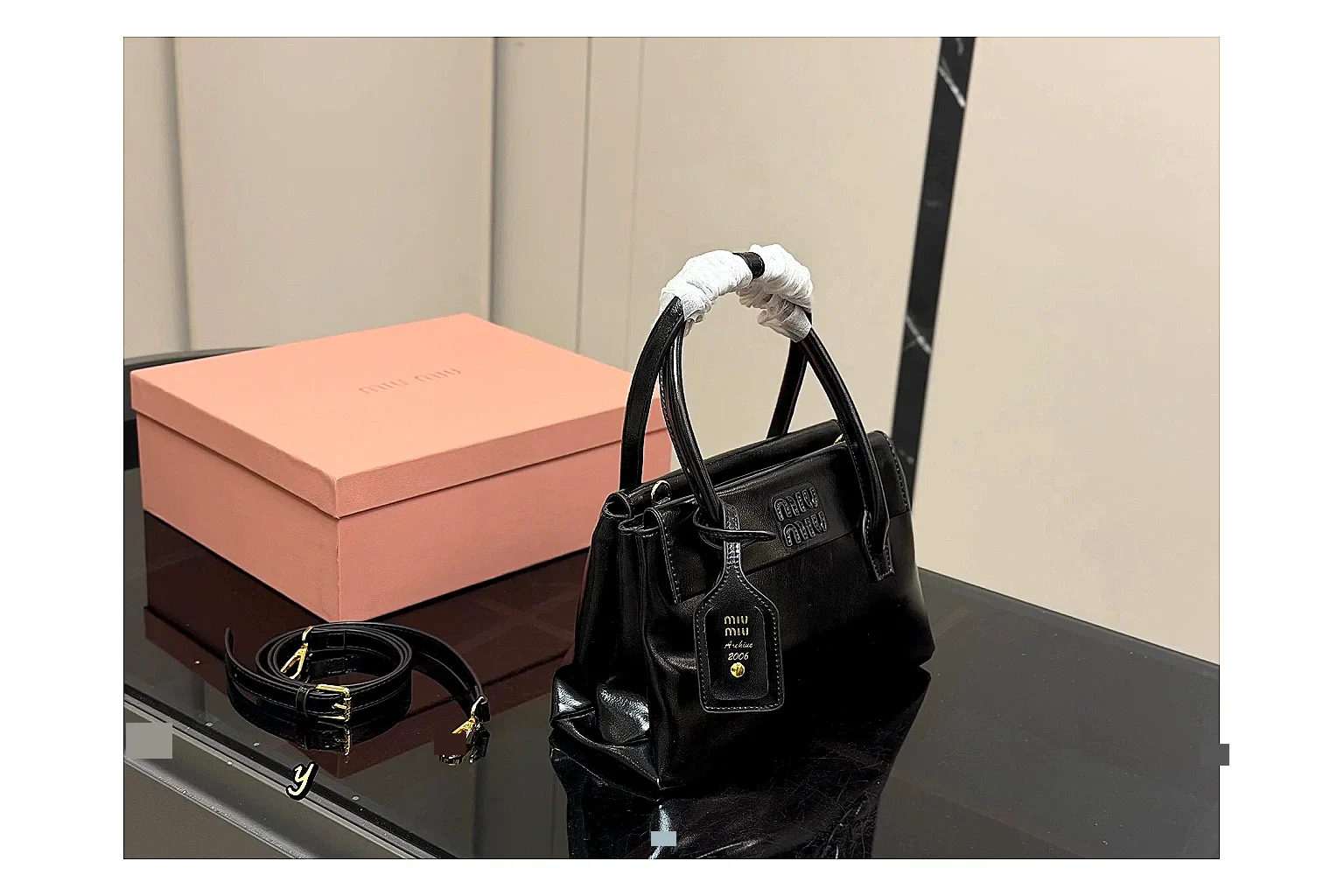 Prada Mini Top Handle Black shopping brief photo showing black leather mini bag body, structured top handle, compact luxury shape, and clean hardware details