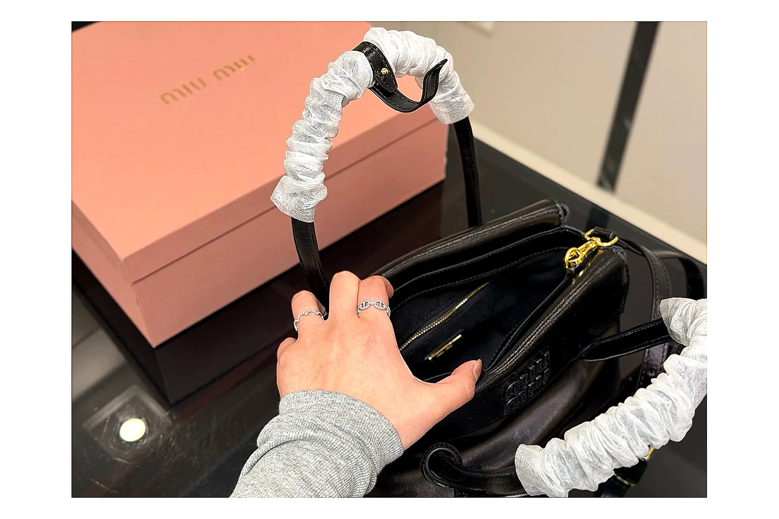 Prada Mini Top Handle Black shopping brief photo showing black leather mini bag body, structured top handle, compact luxury shape, and clean hardware details thumbnail 2