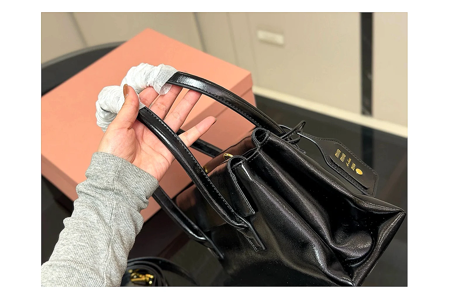 Prada Mini Top Handle Black shopping brief photo showing black leather mini bag body, structured top handle, compact luxury shape, and clean hardware details thumbnail 3
