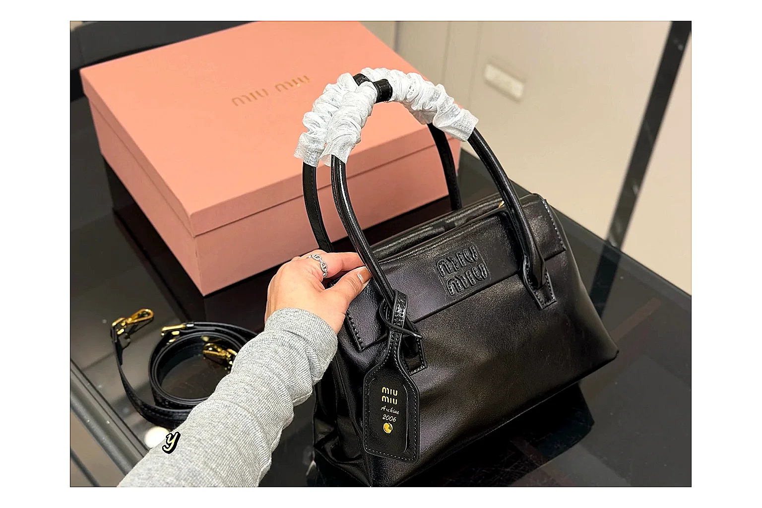 Prada Mini Top Handle Black shopping brief photo showing black leather mini bag body, structured top handle, compact luxury shape, and clean hardware details thumbnail 4