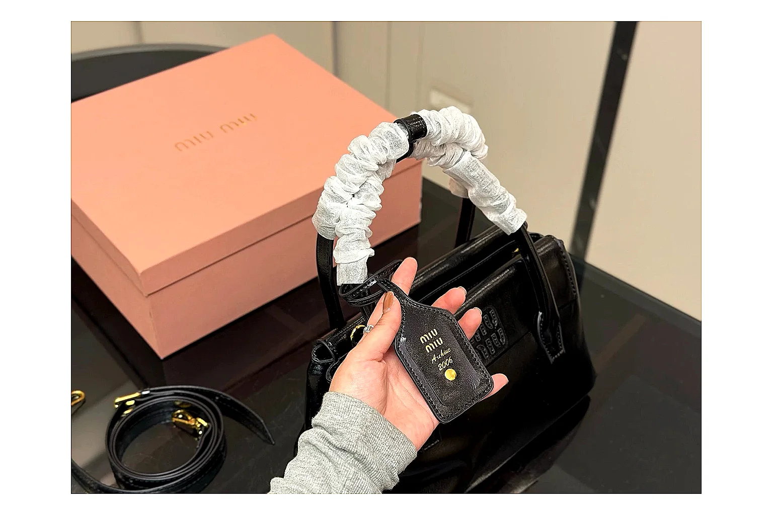 Prada Mini Top Handle Black shopping brief photo showing black leather mini bag body, structured top handle, compact luxury shape, and clean hardware details thumbnail 5
