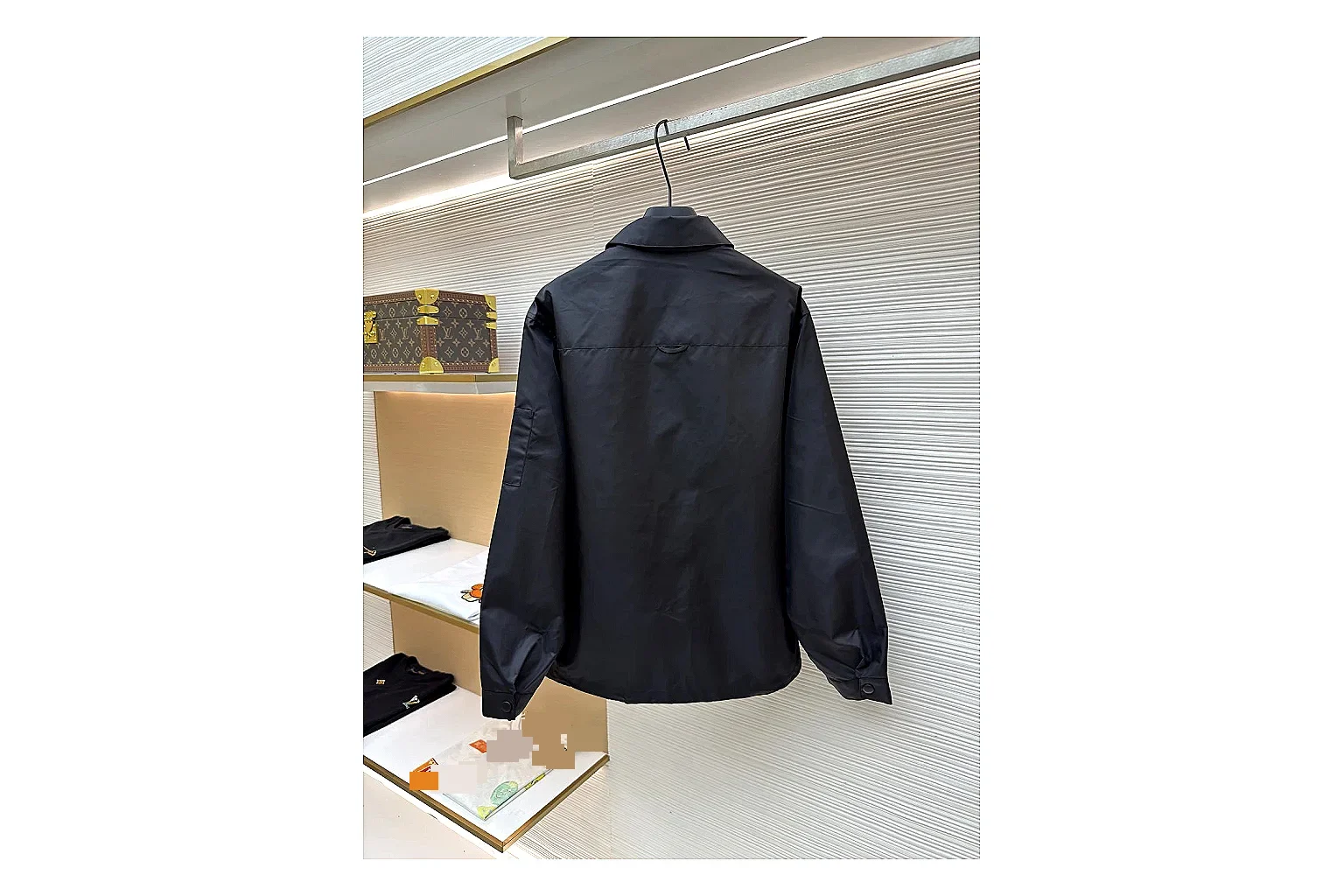 Prada Re-Nylon Hooded Jacket Black Jacket shopping brief image showing black Re-Nylon hooded jacket with recycled-nylon texture, hood structure, zipper line, sleeve cuffs, and light shell shape