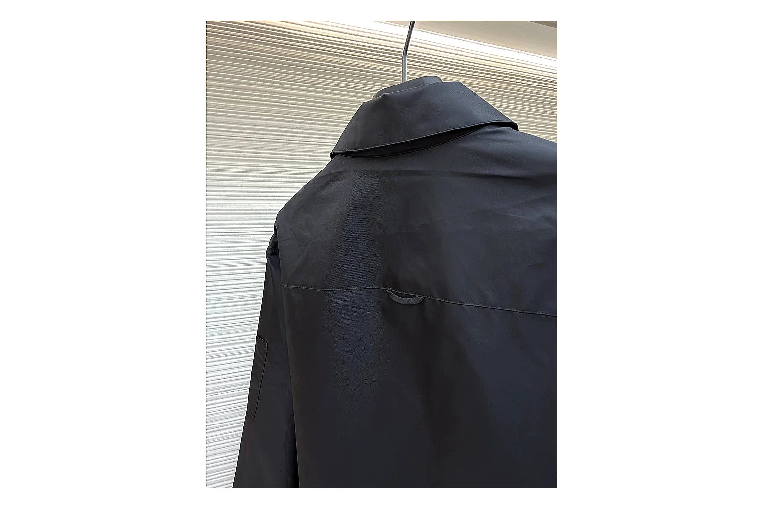 Prada Re-Nylon Hooded Jacket Black Jacket shopping brief image showing black Re-Nylon hooded jacket with recycled-nylon texture, hood structure, zipper line, sleeve cuffs, and light shell shape thumbnail 2