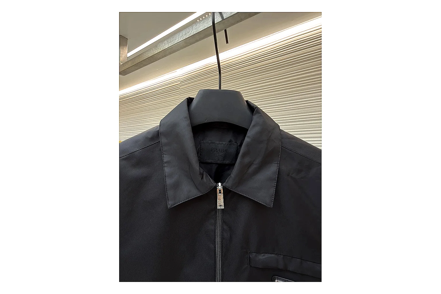 Prada Re-Nylon Hooded Jacket Black Jacket shopping brief image showing black Re-Nylon hooded jacket with recycled-nylon texture, hood structure, zipper line, sleeve cuffs, and light shell shape thumbnail 4