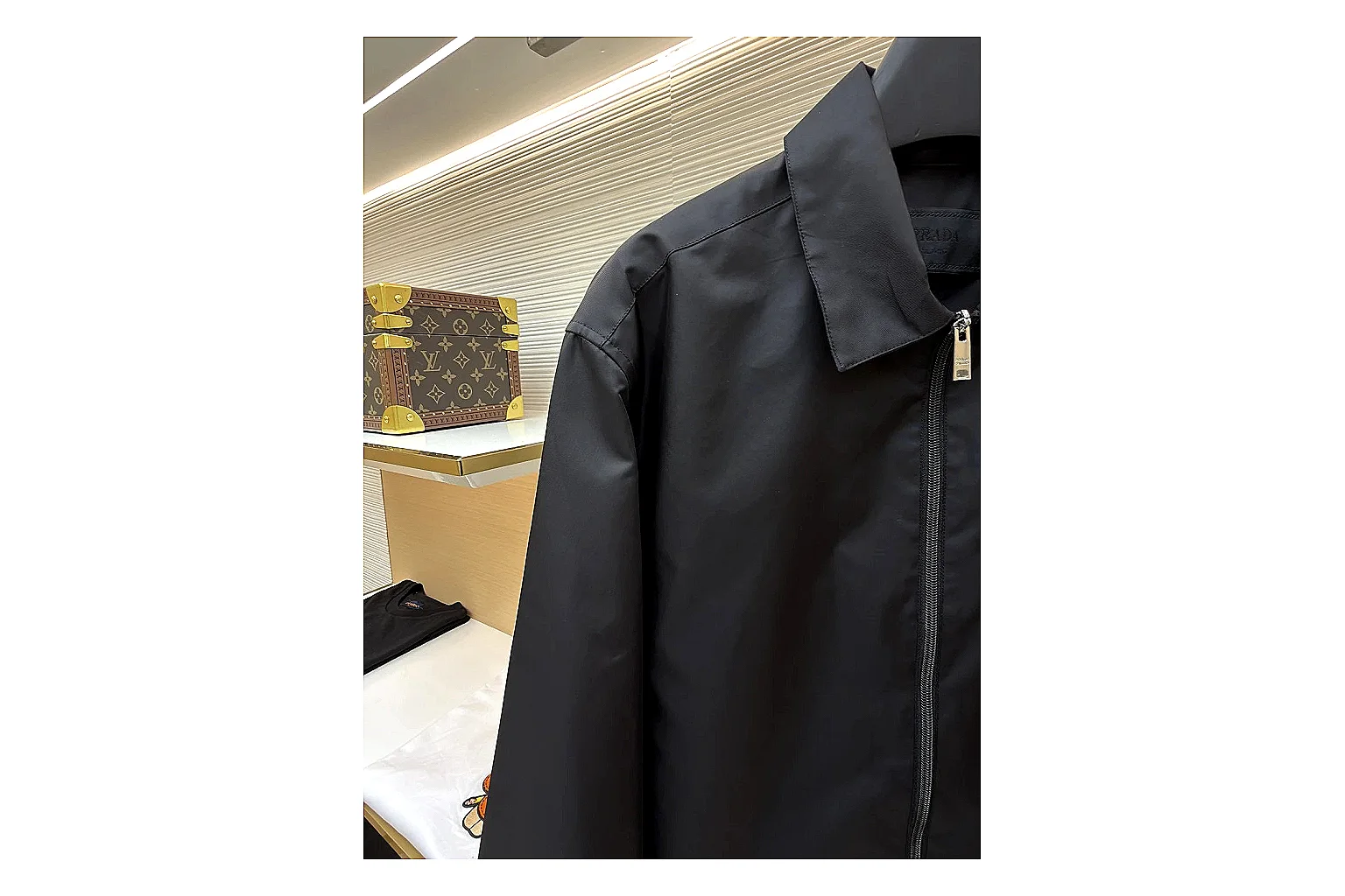 Prada Re-Nylon Hooded Jacket Black Jacket shopping brief image showing black Re-Nylon hooded jacket with recycled-nylon texture, hood structure, zipper line, sleeve cuffs, and light shell shape thumbnail 6